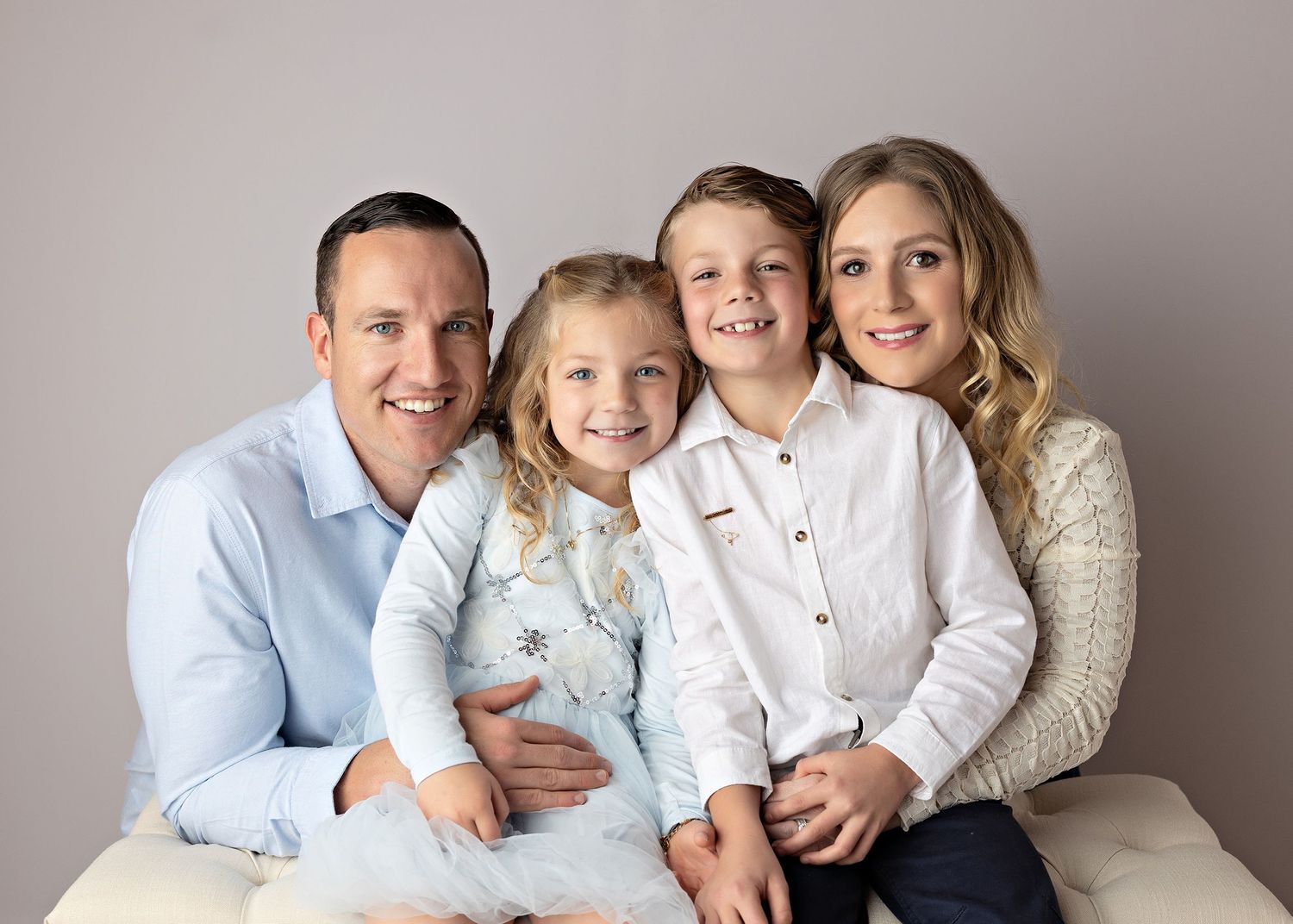 Studio family portrait series showing joyful moments in coordinated light colored outfitsToowoomba Photographer Toowoomba Newborn Photograph