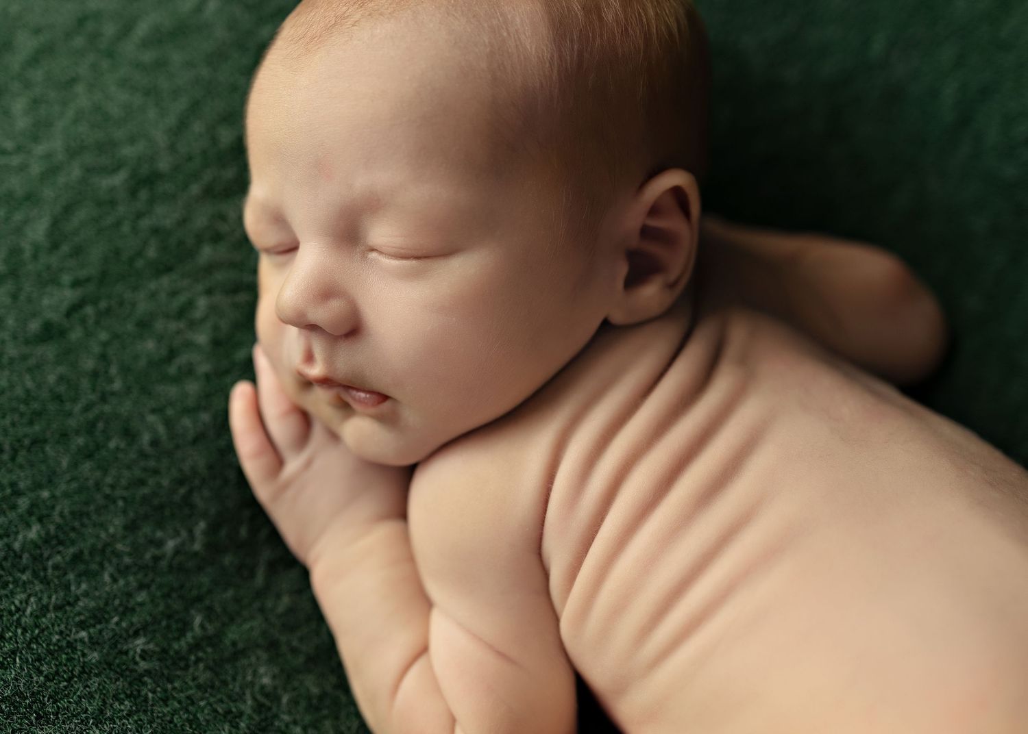 Peaceful sleeping newborn photography series on dark green textured backdropToowoomba Photographer Toowoomba Newborn Photographer