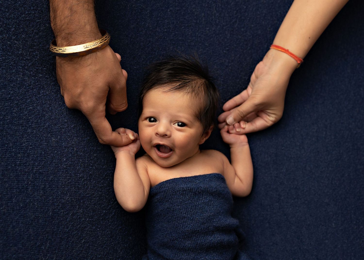 Creative newborn photography sequence against navy blue background showing gentle interactionsToowoomba Photographer Toowoomba Newborn Photo