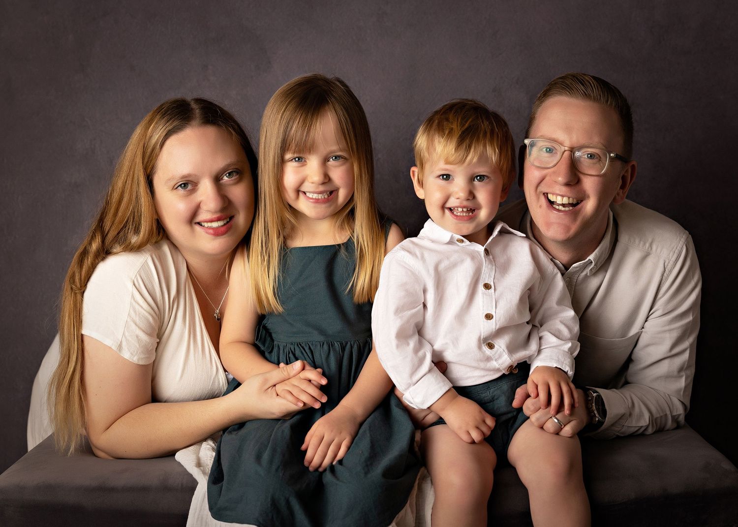 Professional family portrait series showing joyful moments against a dark backgroundToowoomba Photographer Toowoomba Newborn Photographer