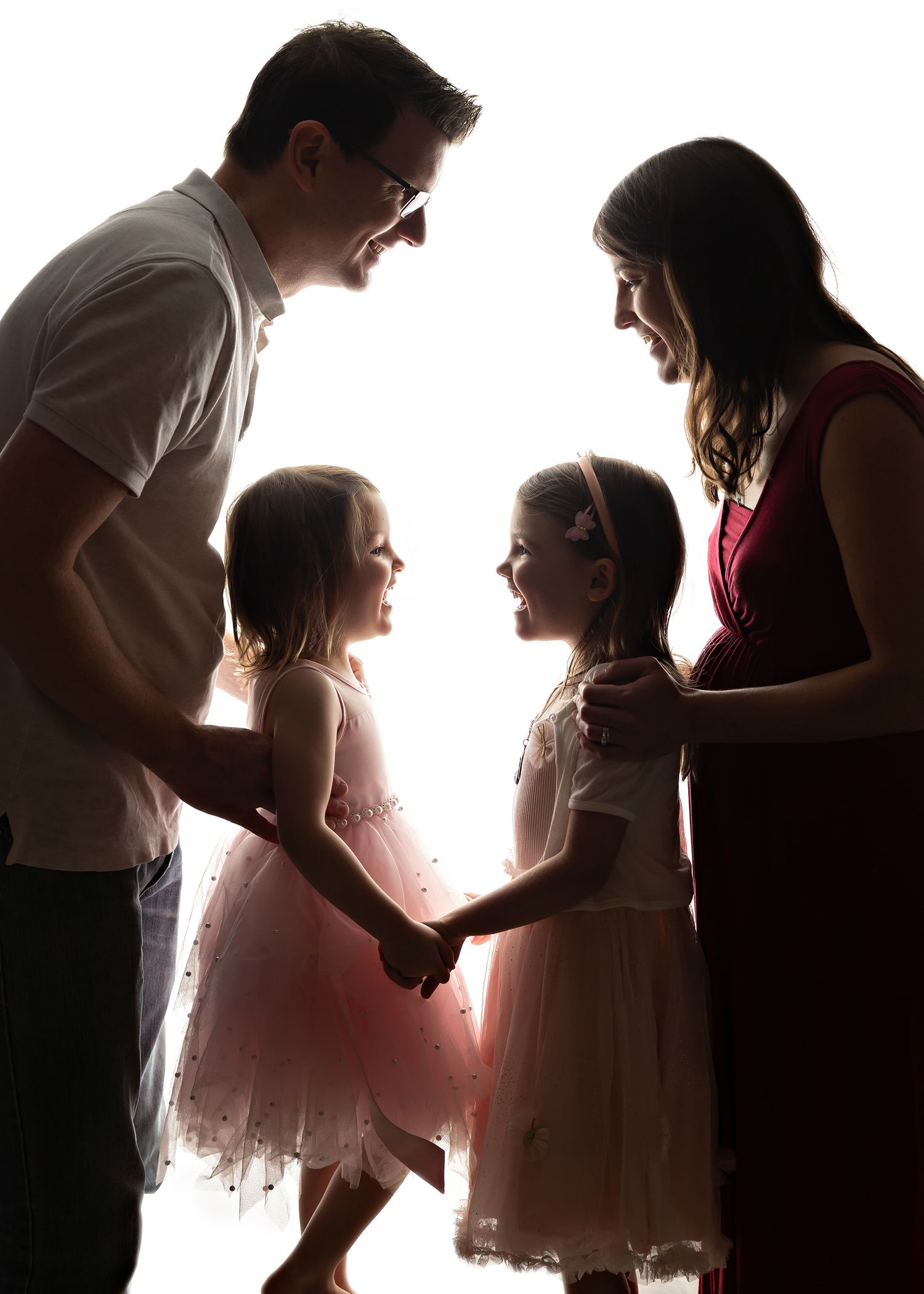 Silhouette series of children in formal wear interacting against bright backgroundToowoomba Photographer Toowoomba Newborn Photographer
