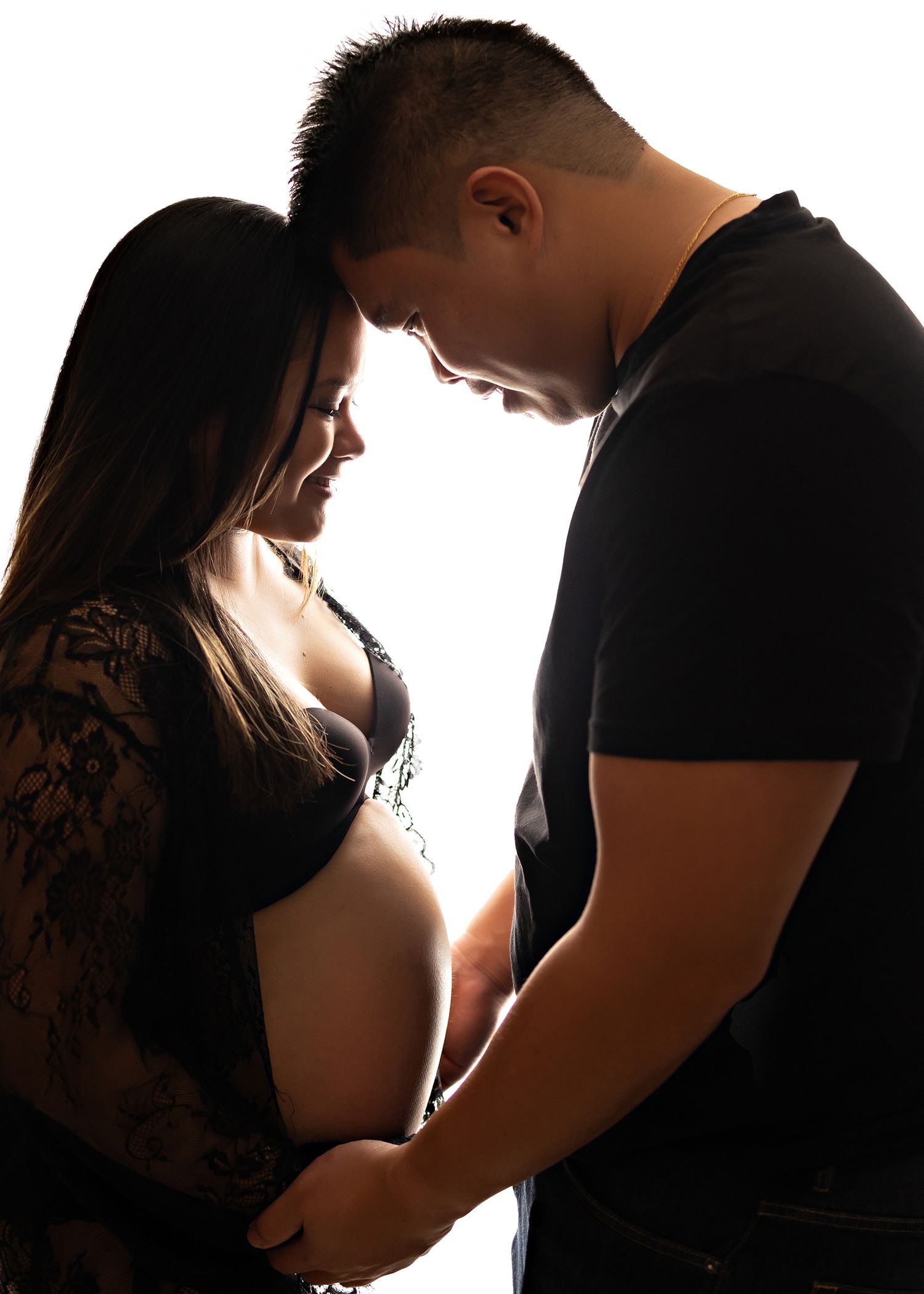 Artistic silhouette series of expectant couple in tender moments against white backdropToowoomba Photographer Toowoomba Newborn Photographer