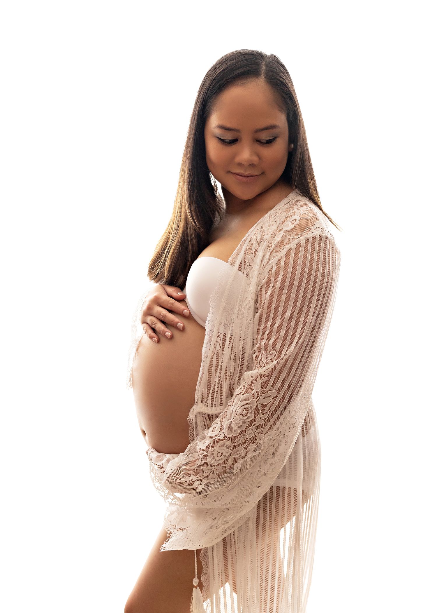 Maternity series showing woman in flowing cream lace dress holding her bellyToowoomba Photographer Toowoomba Newborn Photographer