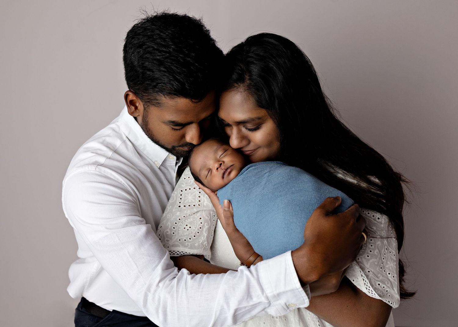 A series of intimate black and white photos showing tender moments between a couple embracing each other.