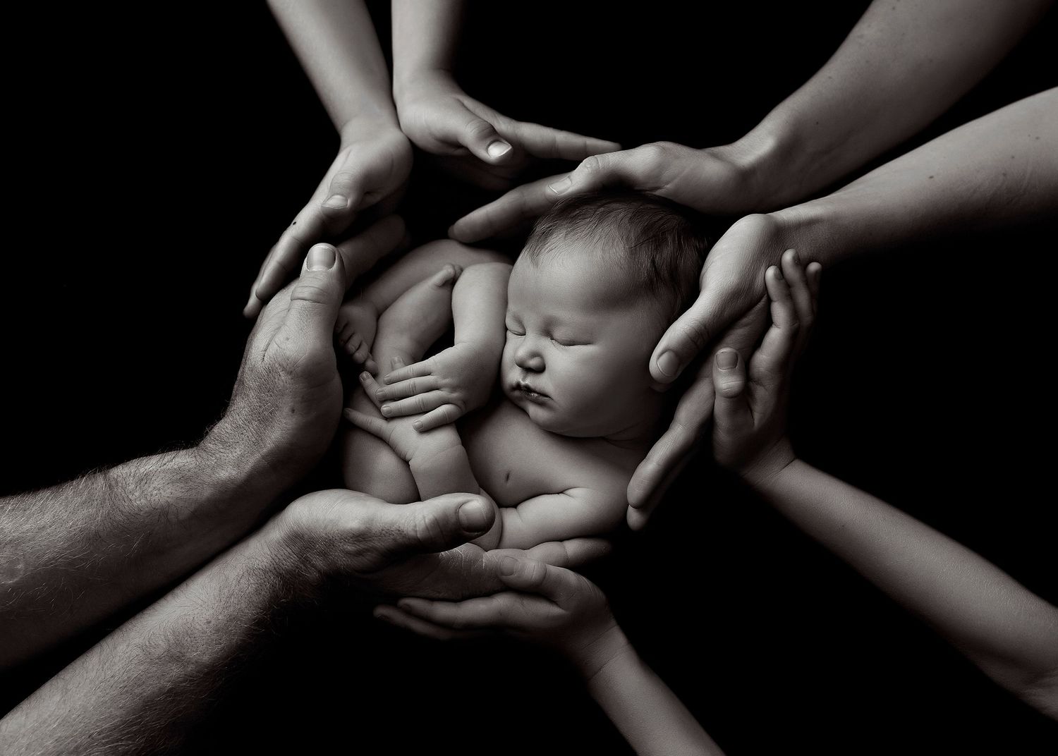 Black and white artistic photography series showing hands cradling a newbornToowoomba Photographer Toowoomba Newborn Photographer