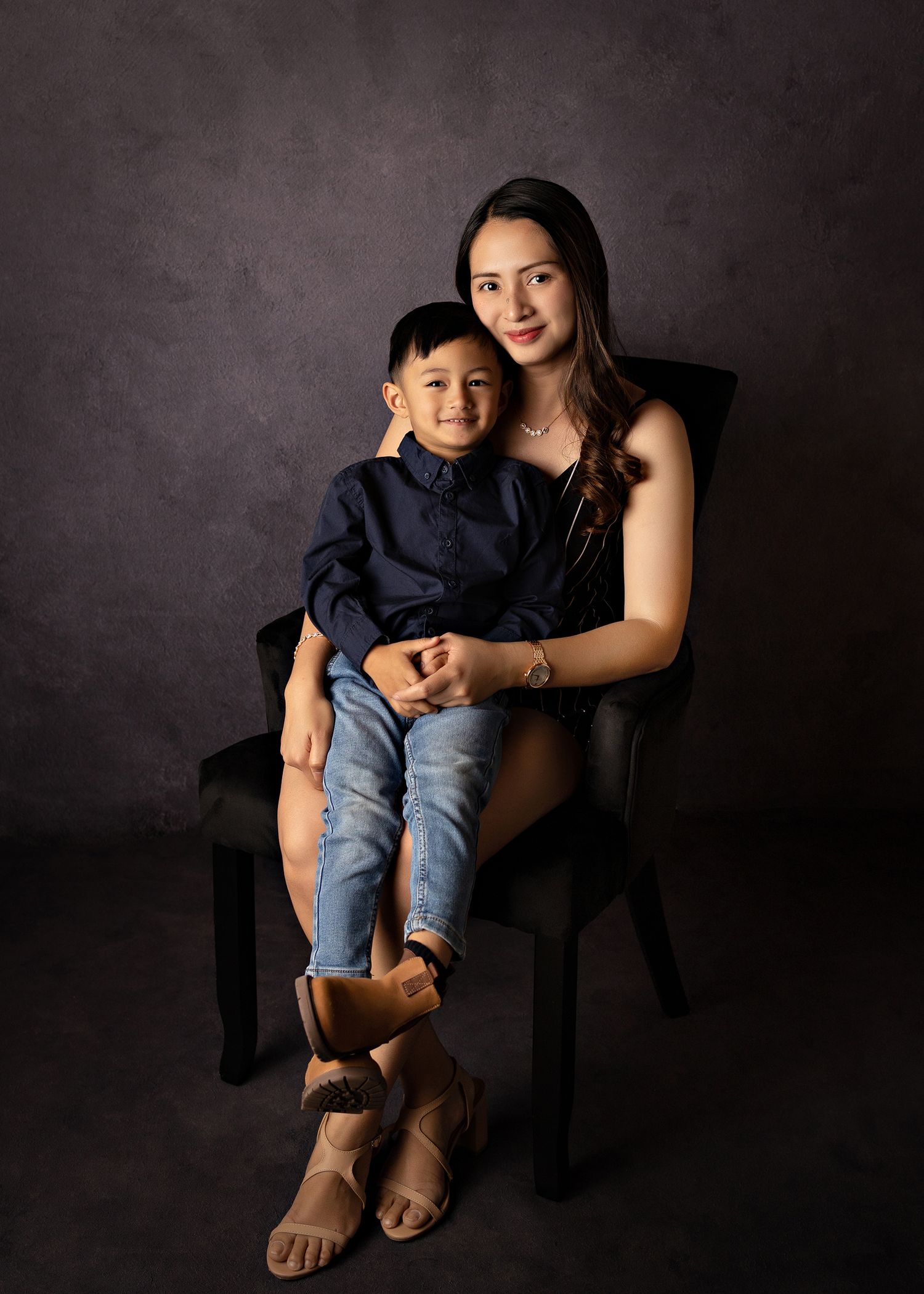 Studio portrait series showing tender family moments against dark backdropToowoomba Photographer Toowoomba Newborn Photographer
