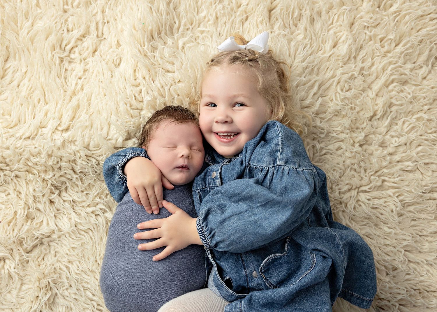 A series of candid shots showing a young child in a denim outfit laying and playing on a cream-colored carpet.