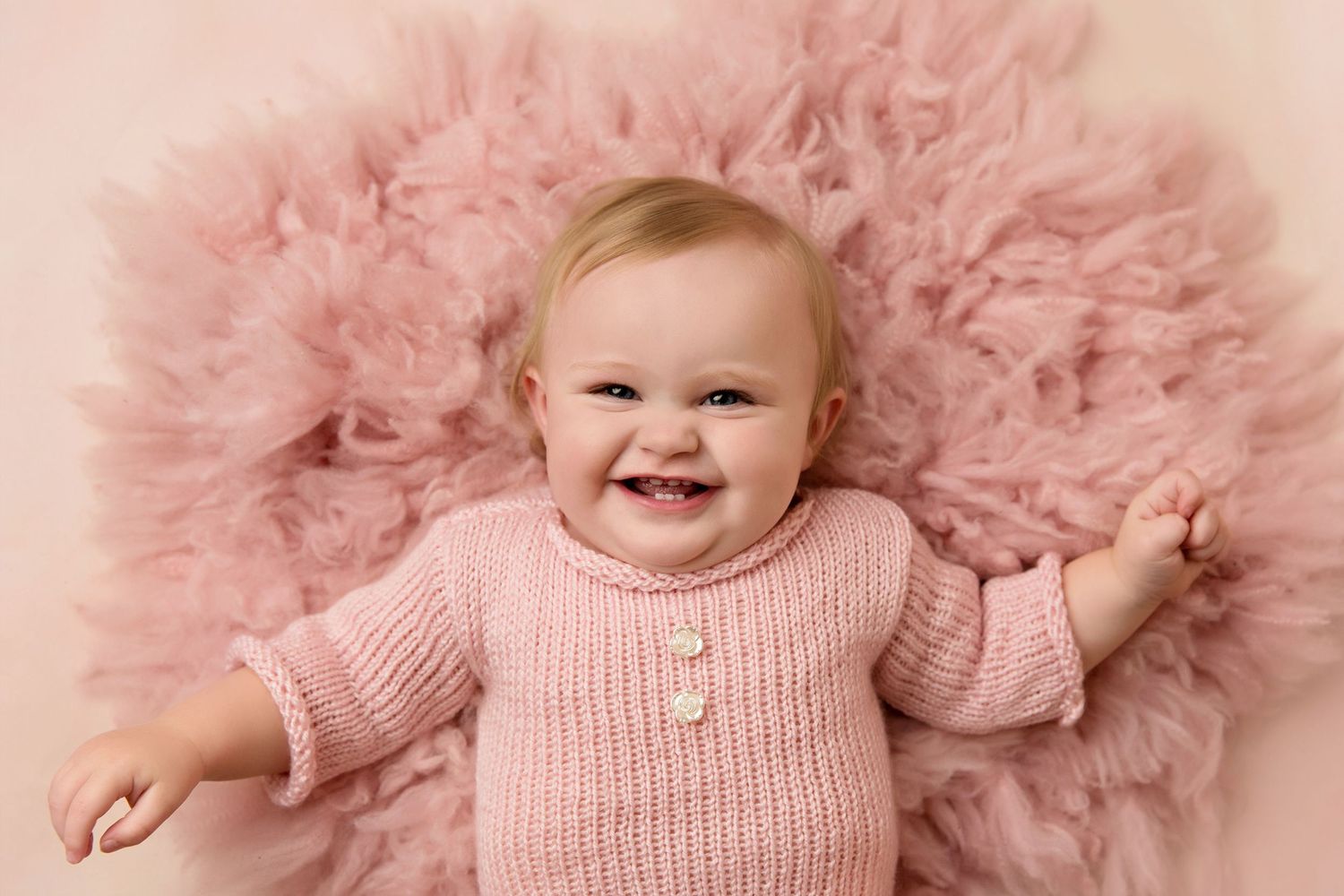 Baby photography session with soft pink tulle background and matching sweaterToowoomba Photographer Toowoomba Newborn Photographer
