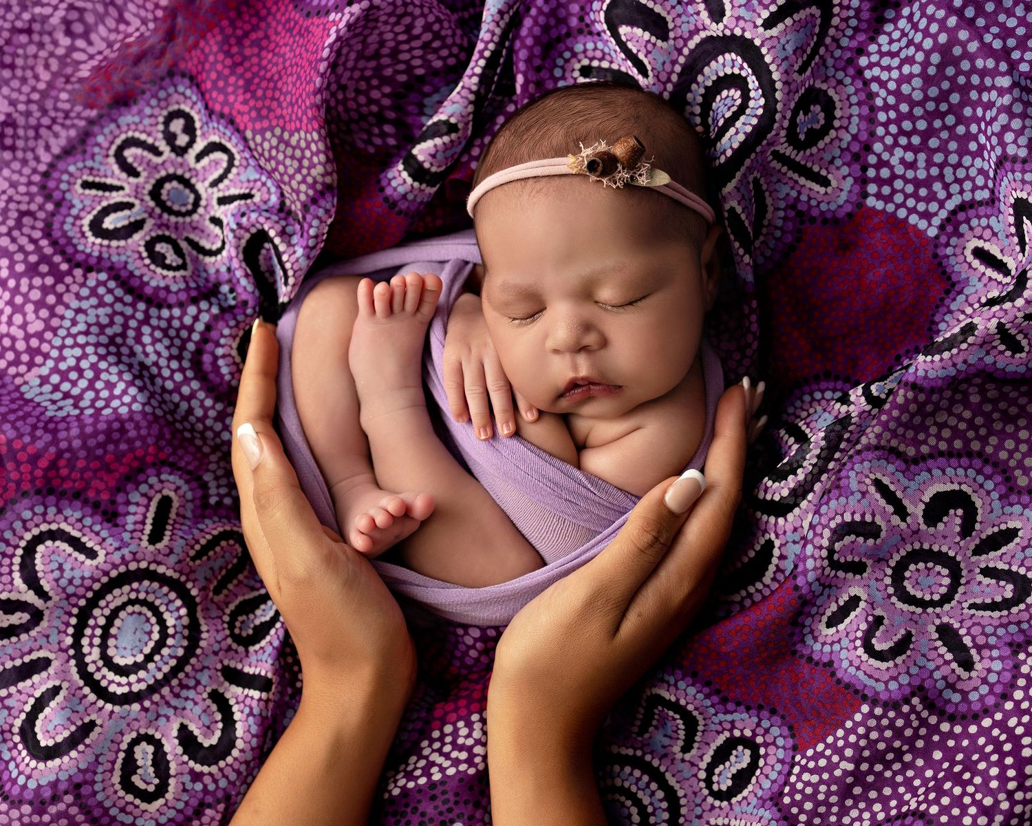 Newborn sleeping peacefully on purple floral patterned blanket in progressive photo sequence.Toowoomba Photographer