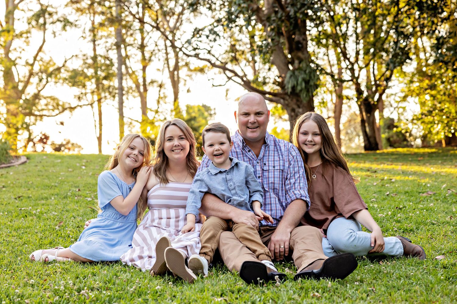 Family photo session in a park during golden hour with natural lightingToowoomba Photographer Toowoomba Newborn Photographer