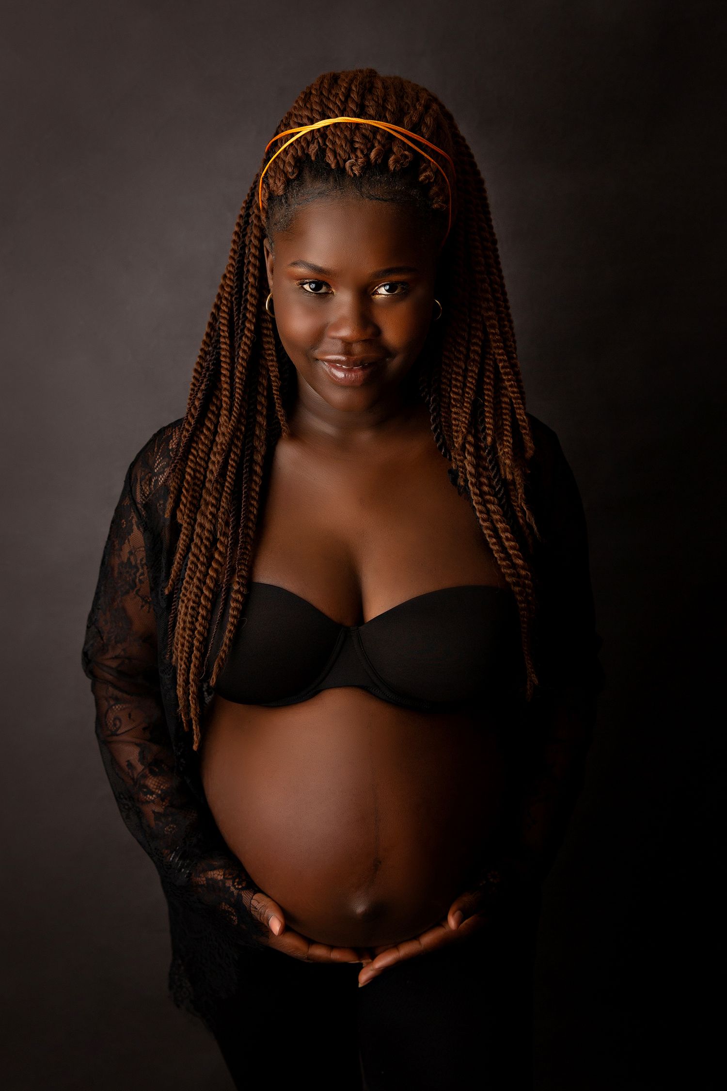 Maternity portrait series featuring woman in black lace robe against dark backgroundToowoomba Photographer Toowoomba Newborn Photographer