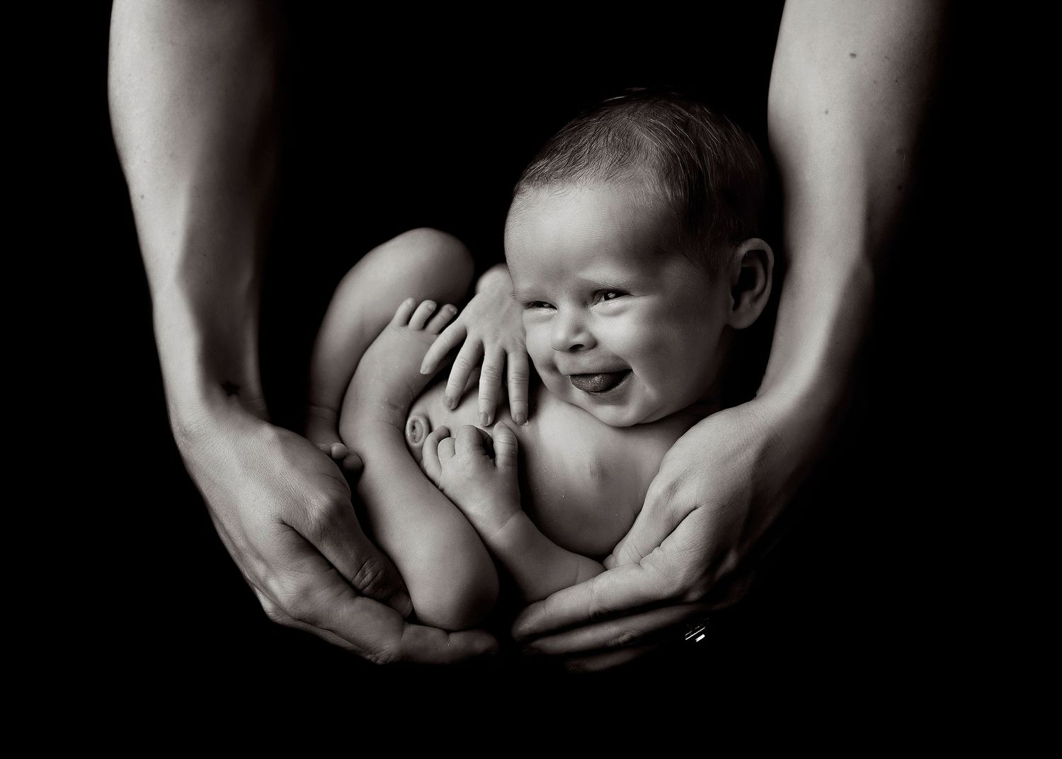 Dramatic black and white newborn photography series with gentle hands cradling babyToowoomba Photographer Toowoomba Newborn Photographer