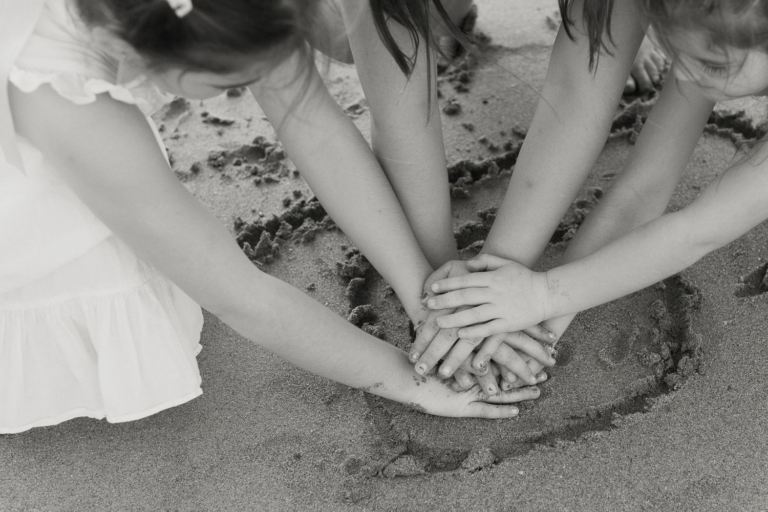children's hands and sand