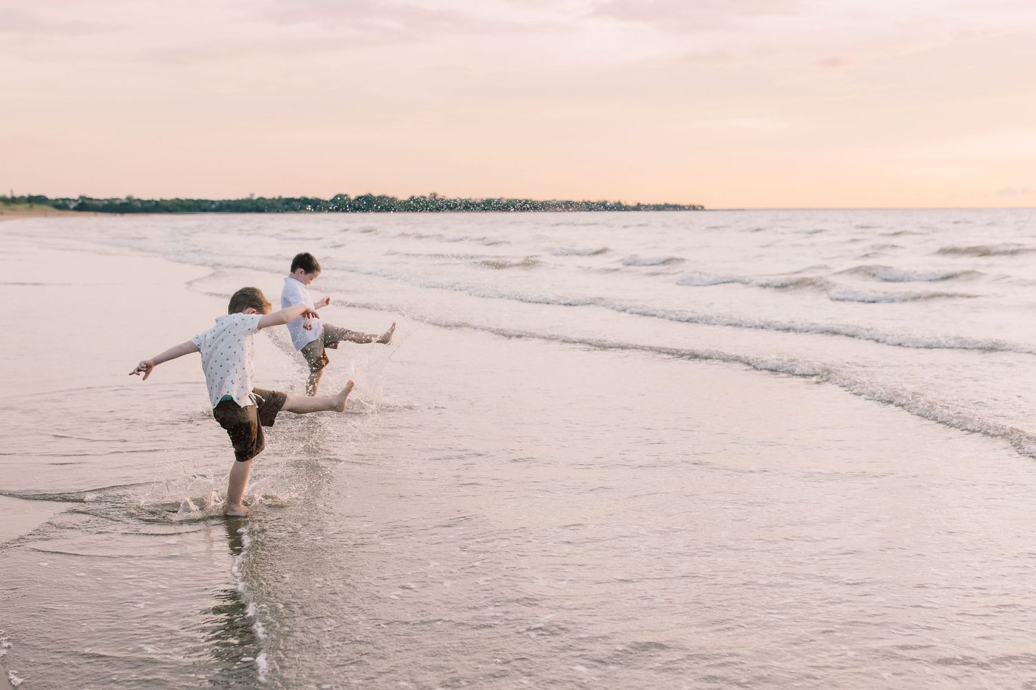 brothers playing in the ocean