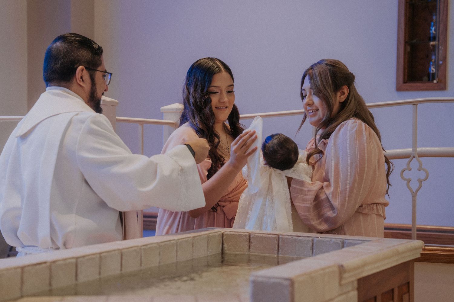 A group of people  participating in a baptism ceremony at a church.