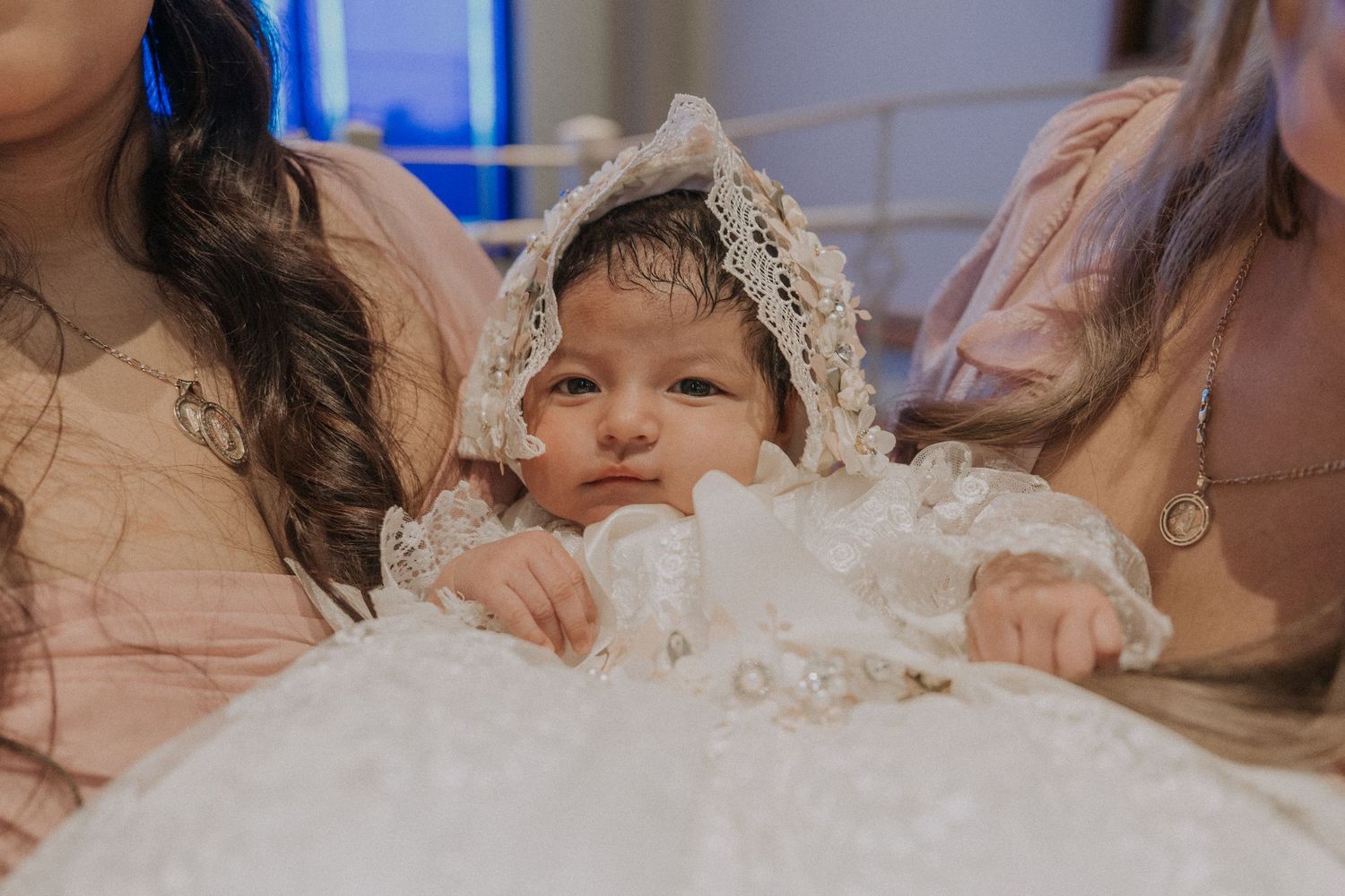 Participants in formal attire during a baptism ceremony in church.