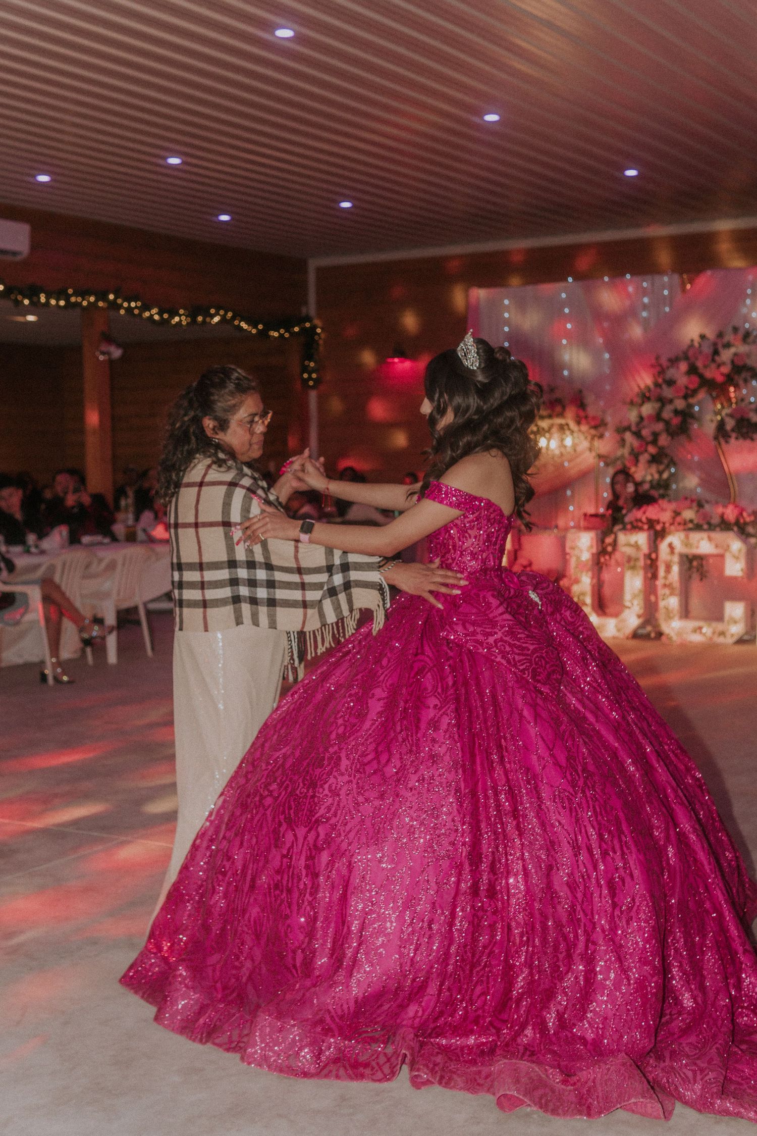 Dance floor scene with dramatic hot pink ball gown in motion.