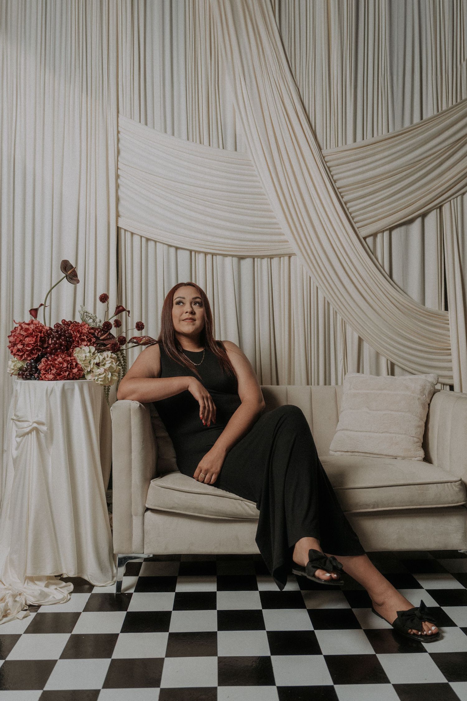 Artistic color photo series featuring poses on a light colored sofa against draped fabric.
