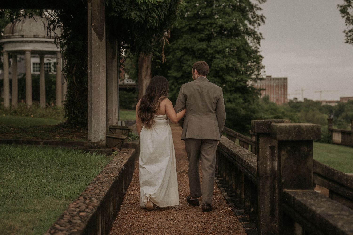 Outdoor engagement photography session with scenic overlook and elegant stone railing.