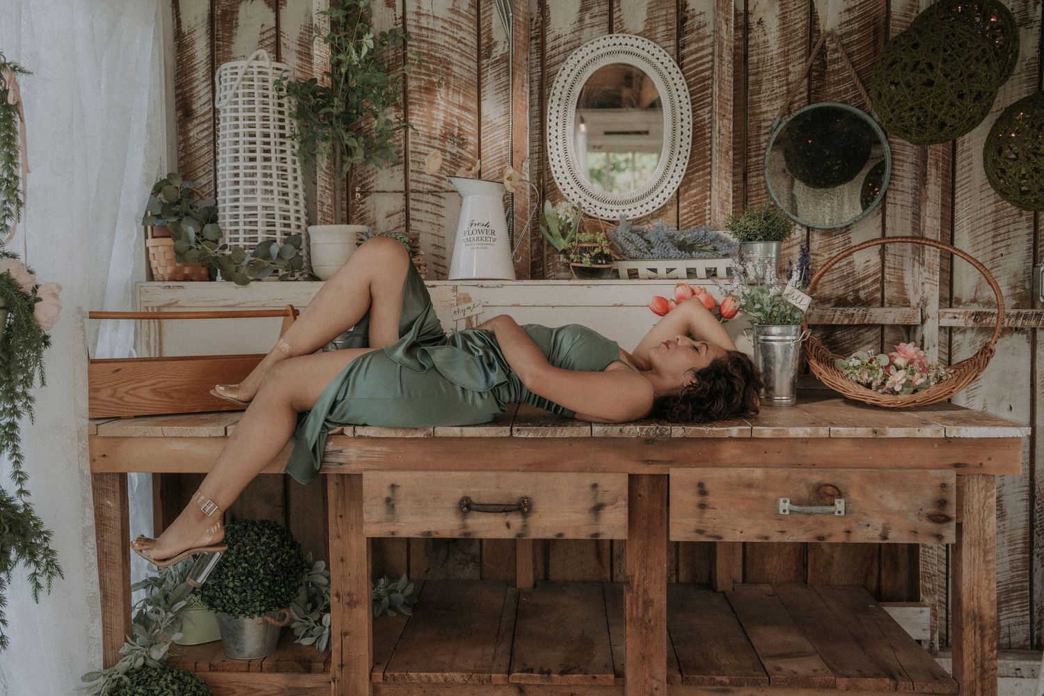 Vintage-style room with wooden furniture and hanging greenery creating a romantic atmosphere.