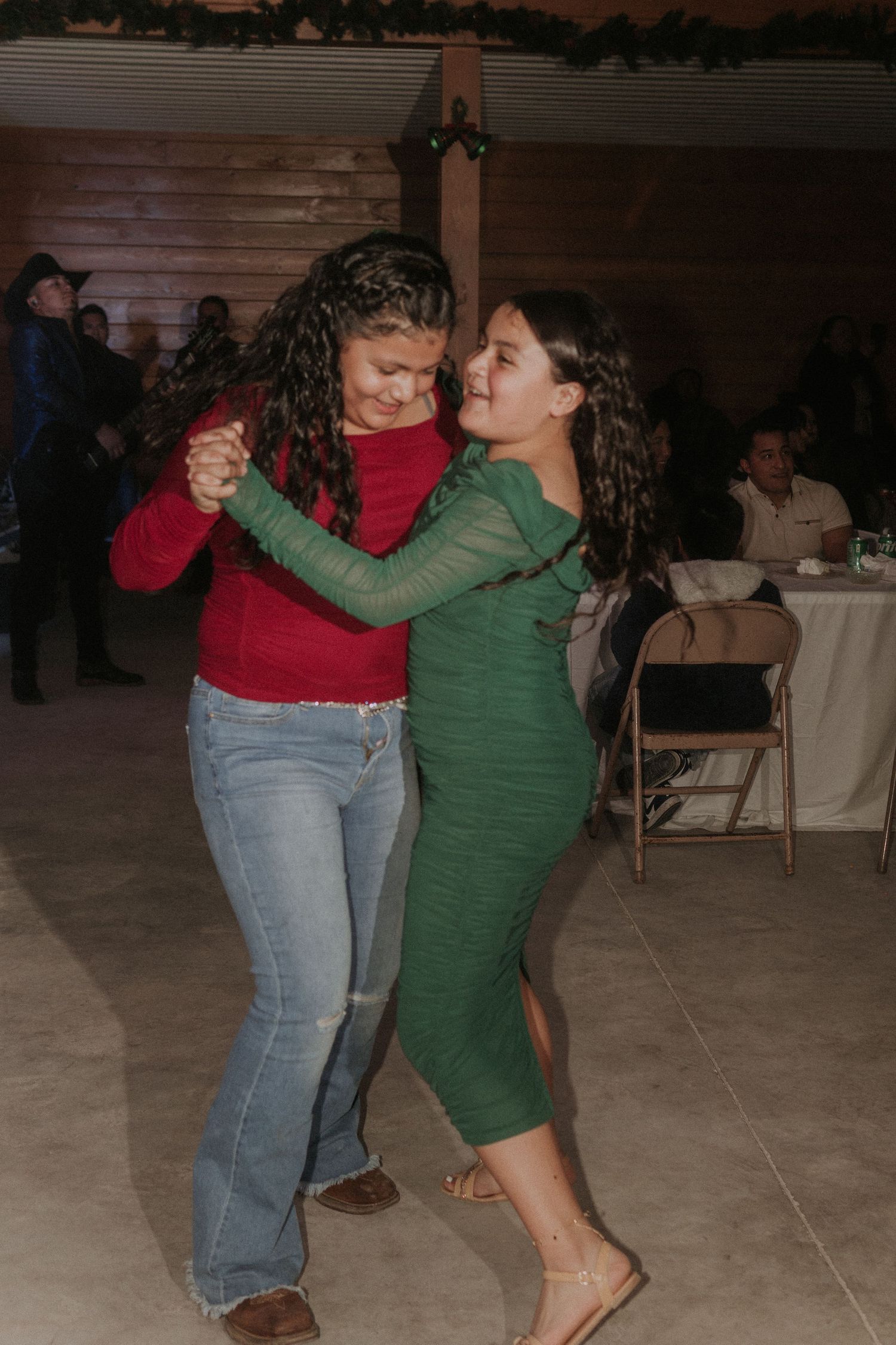 Young teens dancing together on a wooden floor at a Sweet 16 party