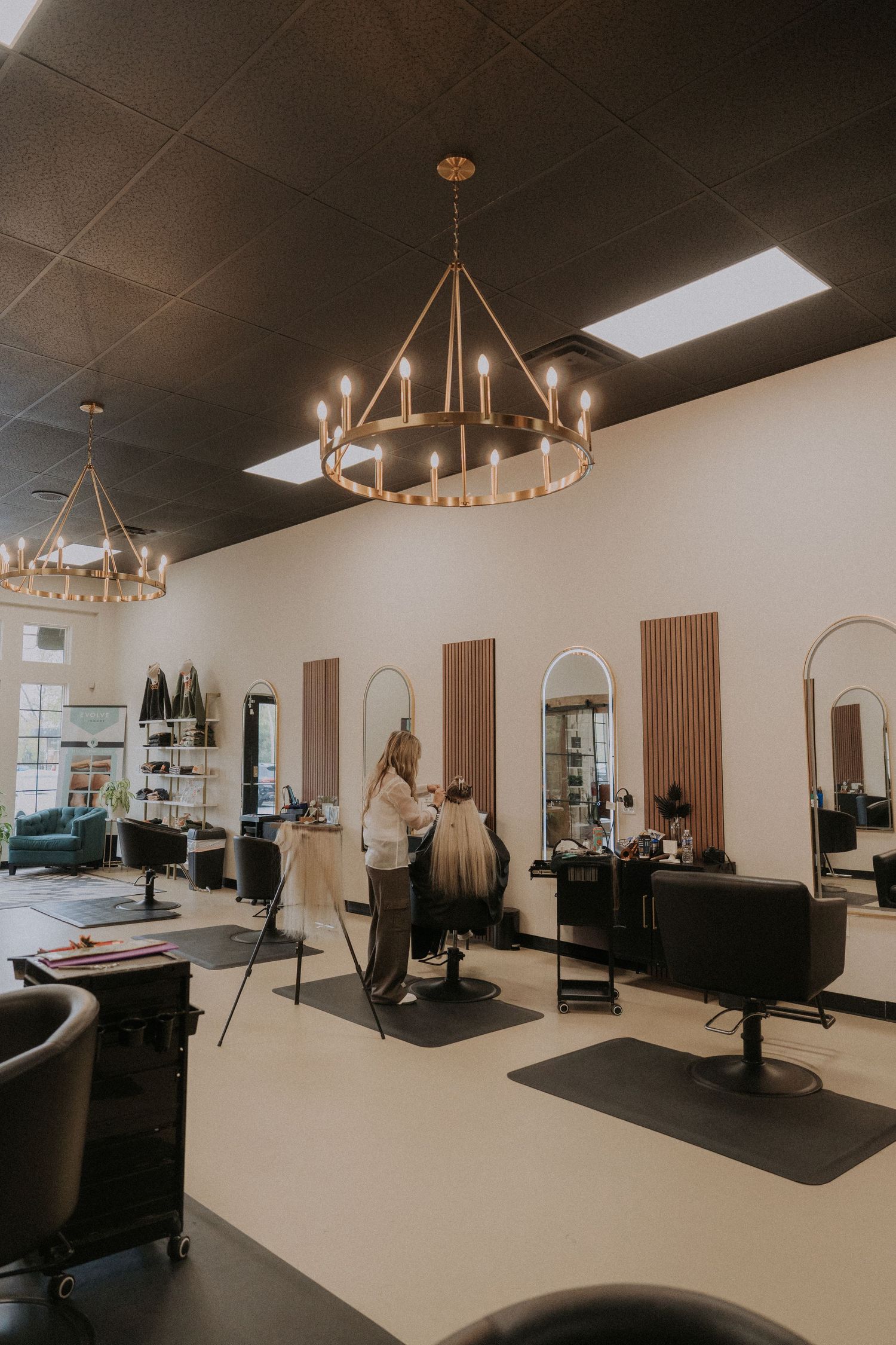 Modern salon interior with elegant lighting fixtures and minimalist white decor.