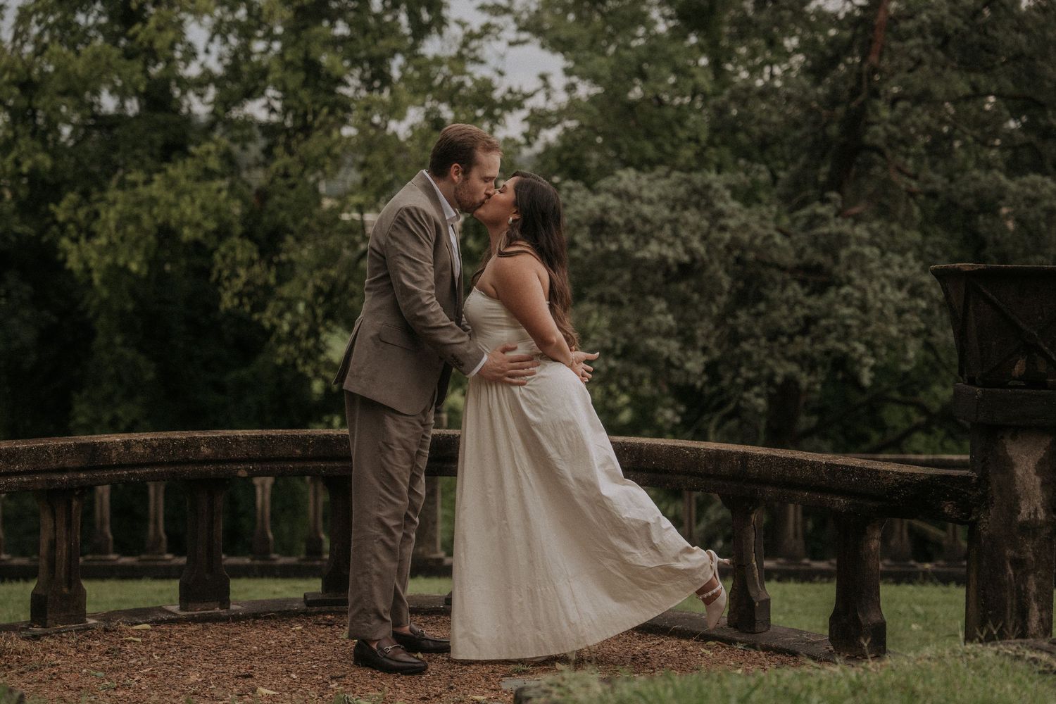 Romantic dance sequence during an engagement session in an elegant outdoor setting with soft natural lighting.