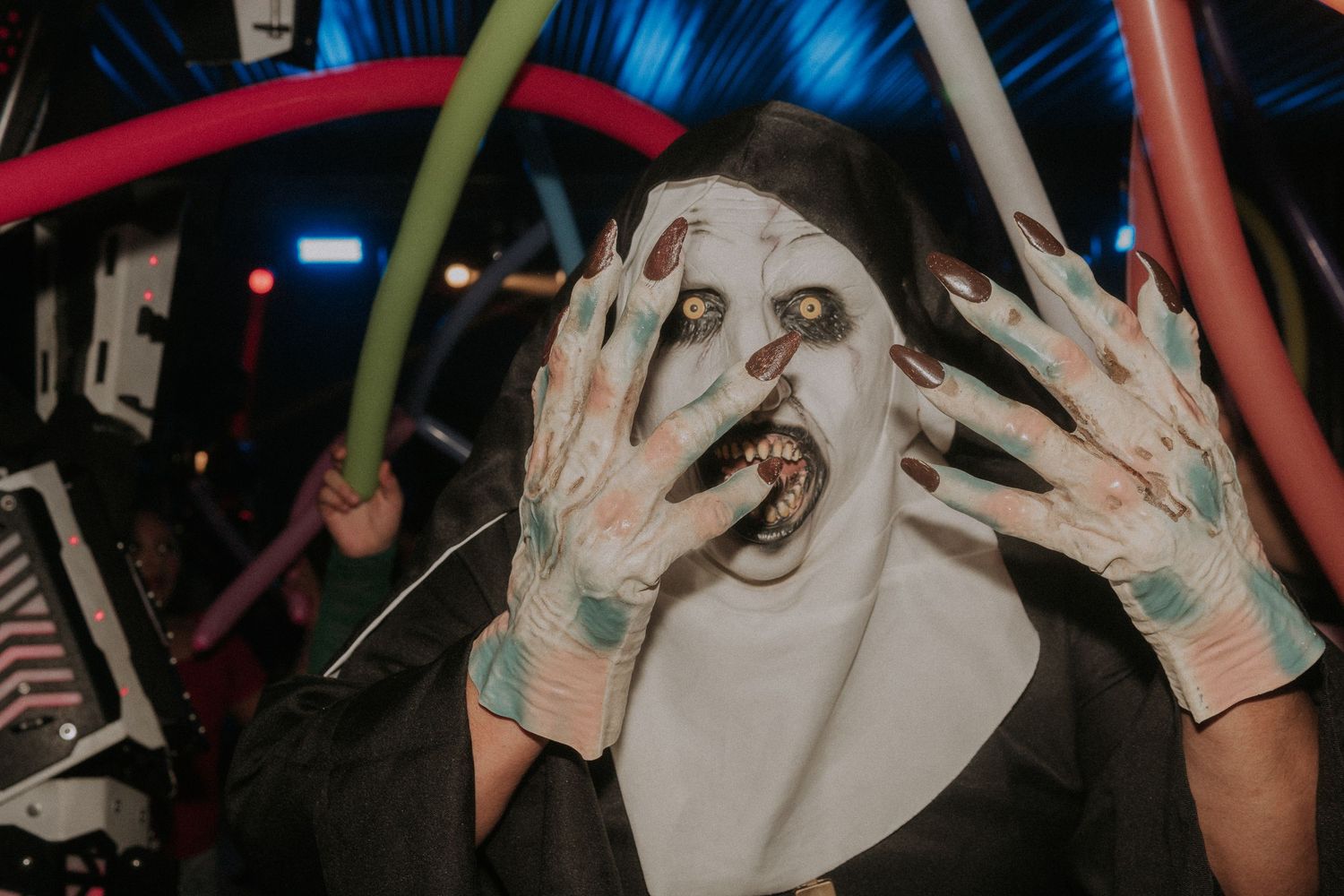 The Nun dancing and celebrating at a Sweet 16 party with balloons creating a festive atmosphere.