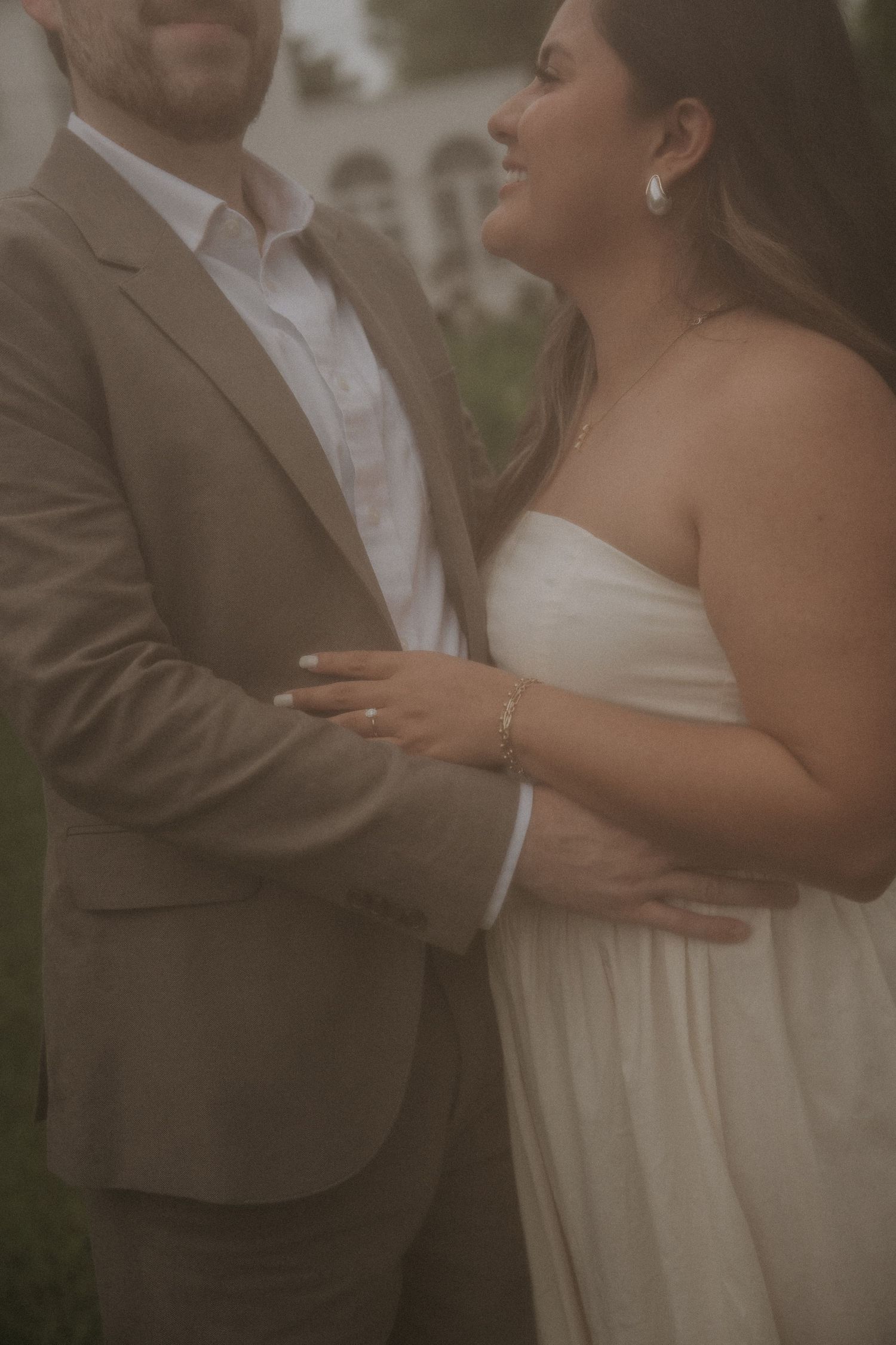 Intimate engagement portraits showing tender moments between a couple in formal attire.
