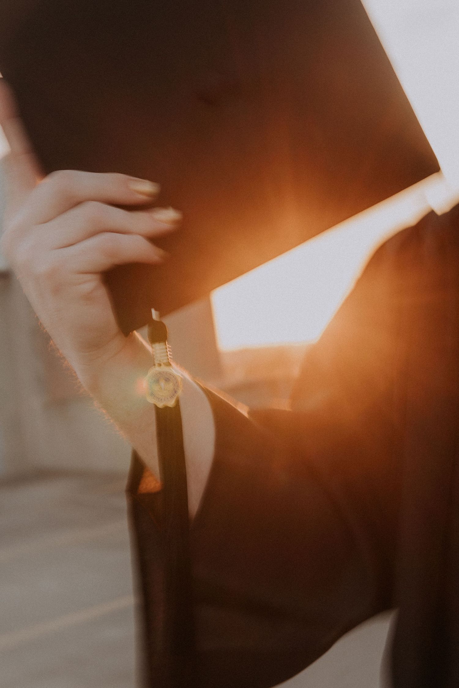 A close-up shot of a graduation cap during a sunlit background.