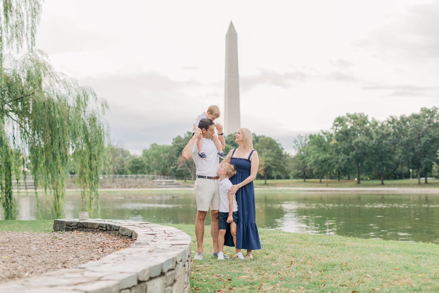 A candid family moment captured near the reflecting pool at the National Mall.