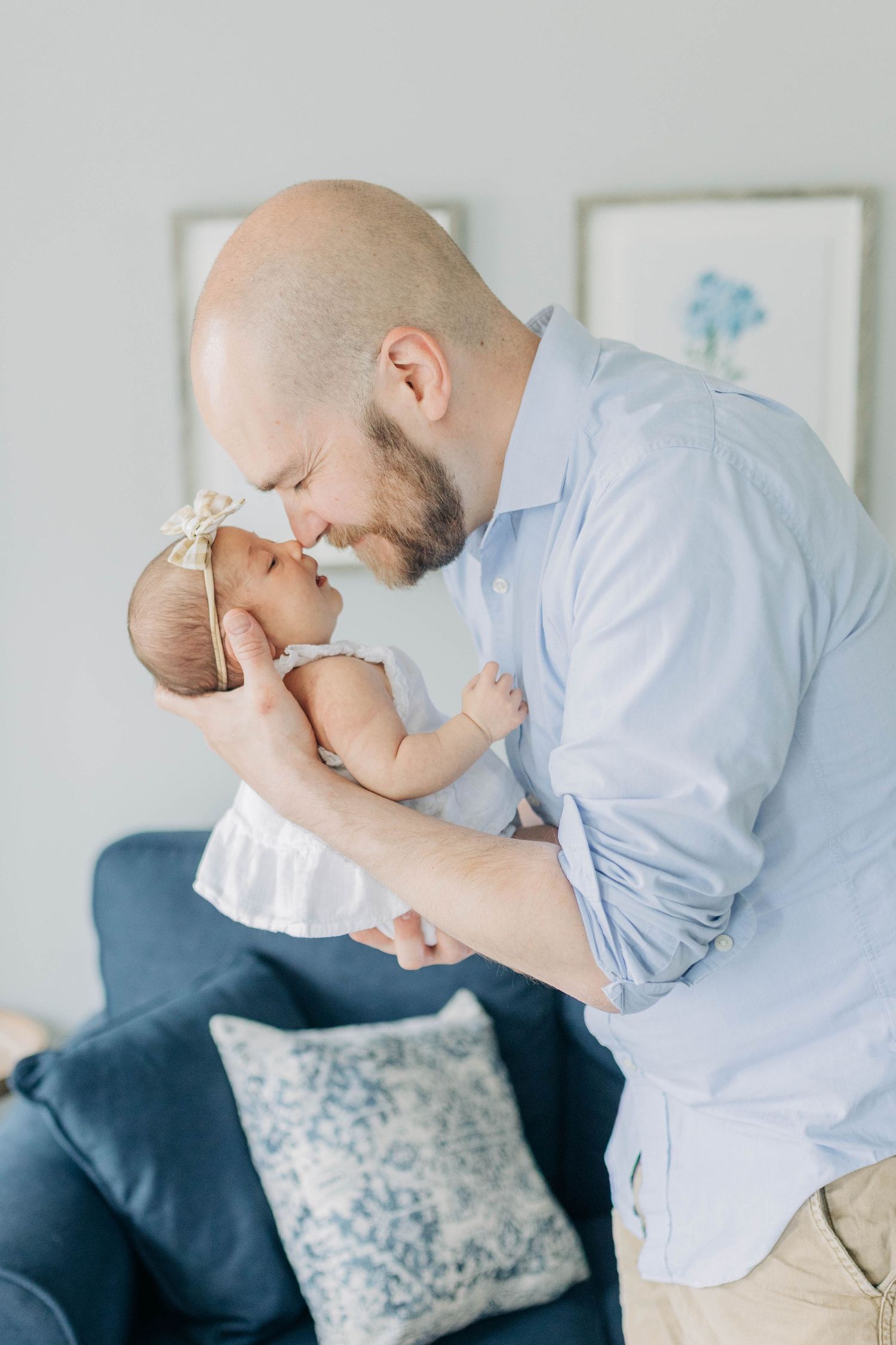Intimate moments captured between parent and infant in soft, natural lighting.