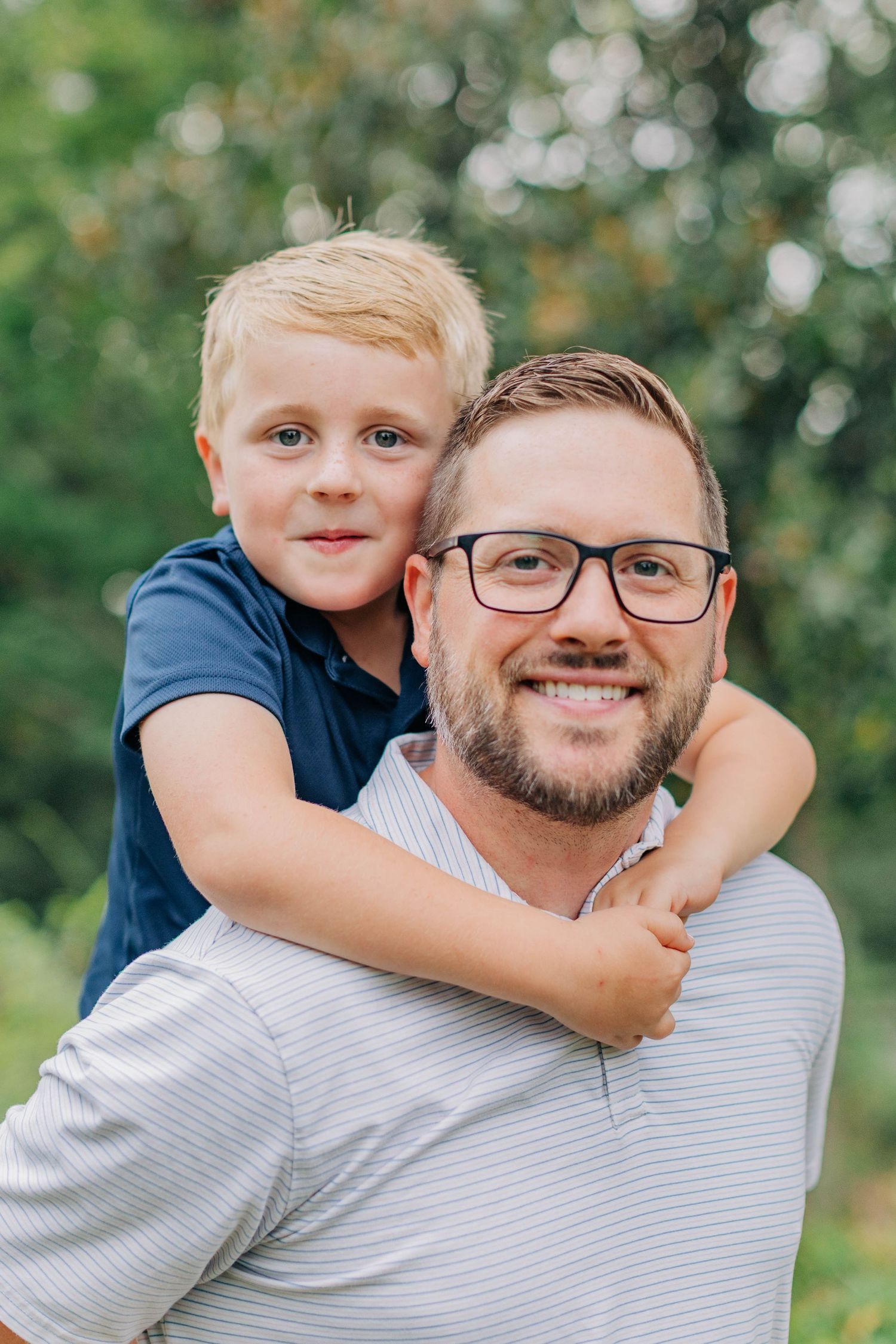 Heartwarming piggyback ride moment captured in an outdoor setting.