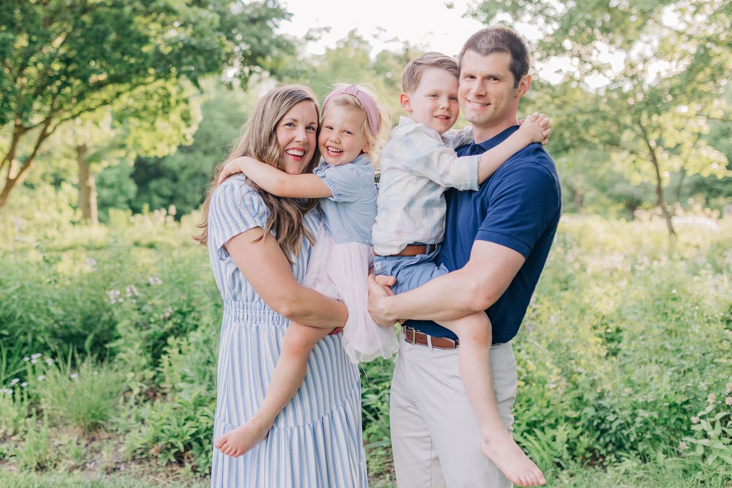 A family shares loving embraces while enjoying time together outdoors.