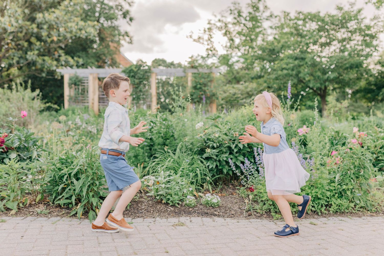 Casual outdoor family photography session in a garden pathway setting.