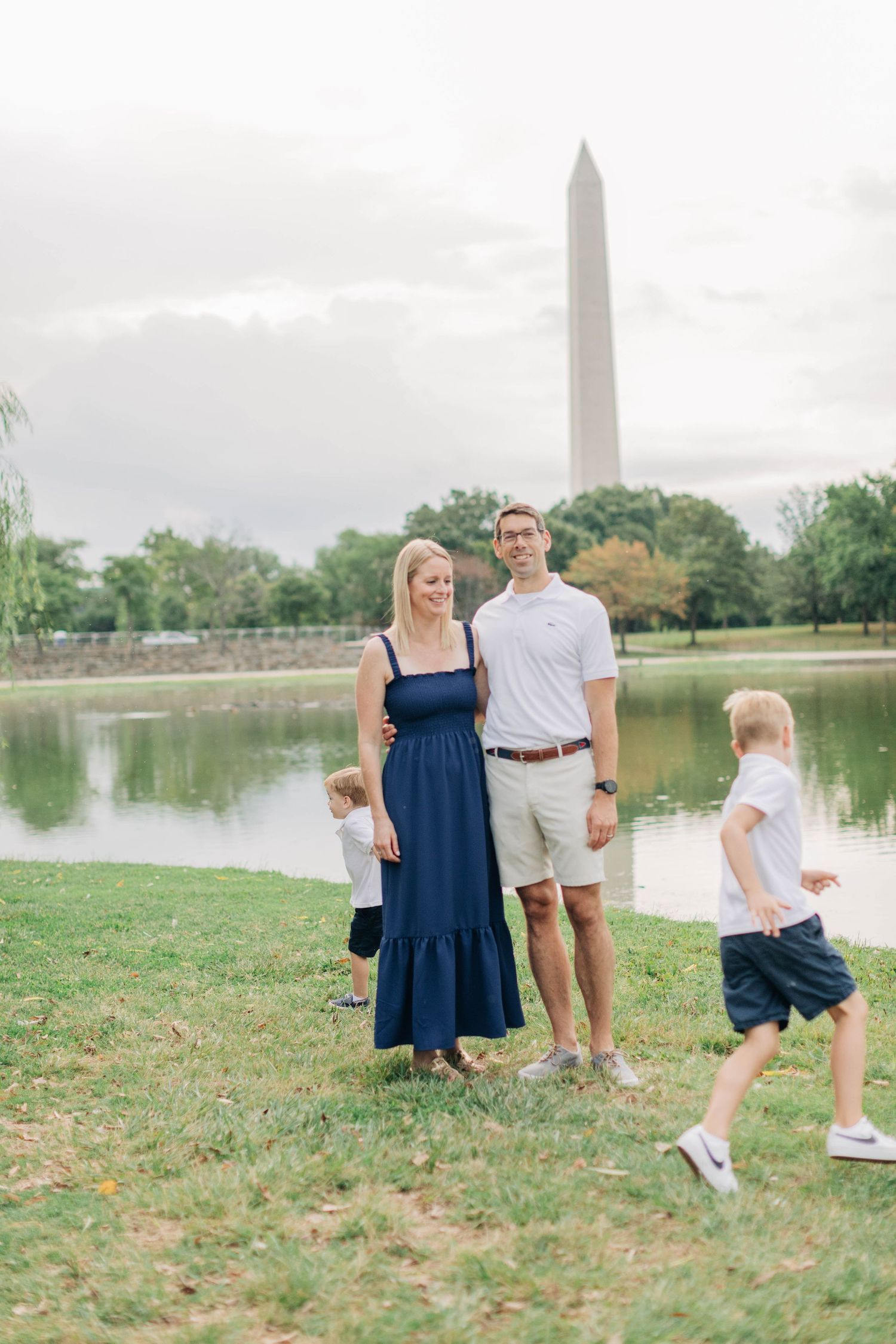 Family spending time together near the Washington Monument and reflecting pool.