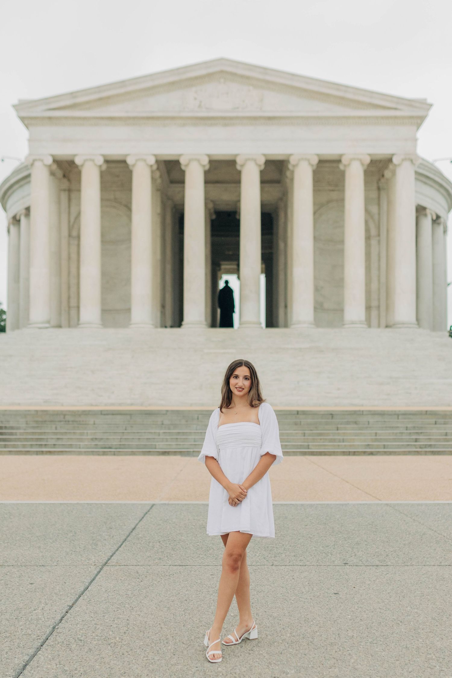 White summer dress photo in front of the Jefferson Memorial's neoclassical architecture.
