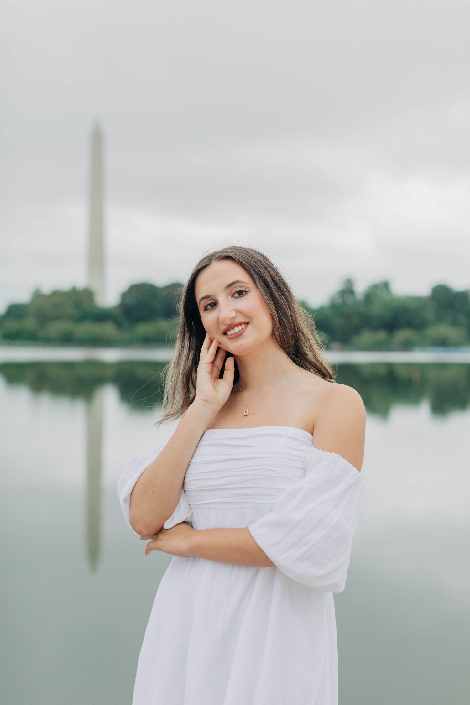 Candid moments captured by the water with the Washington Monument reflecting in the distance.