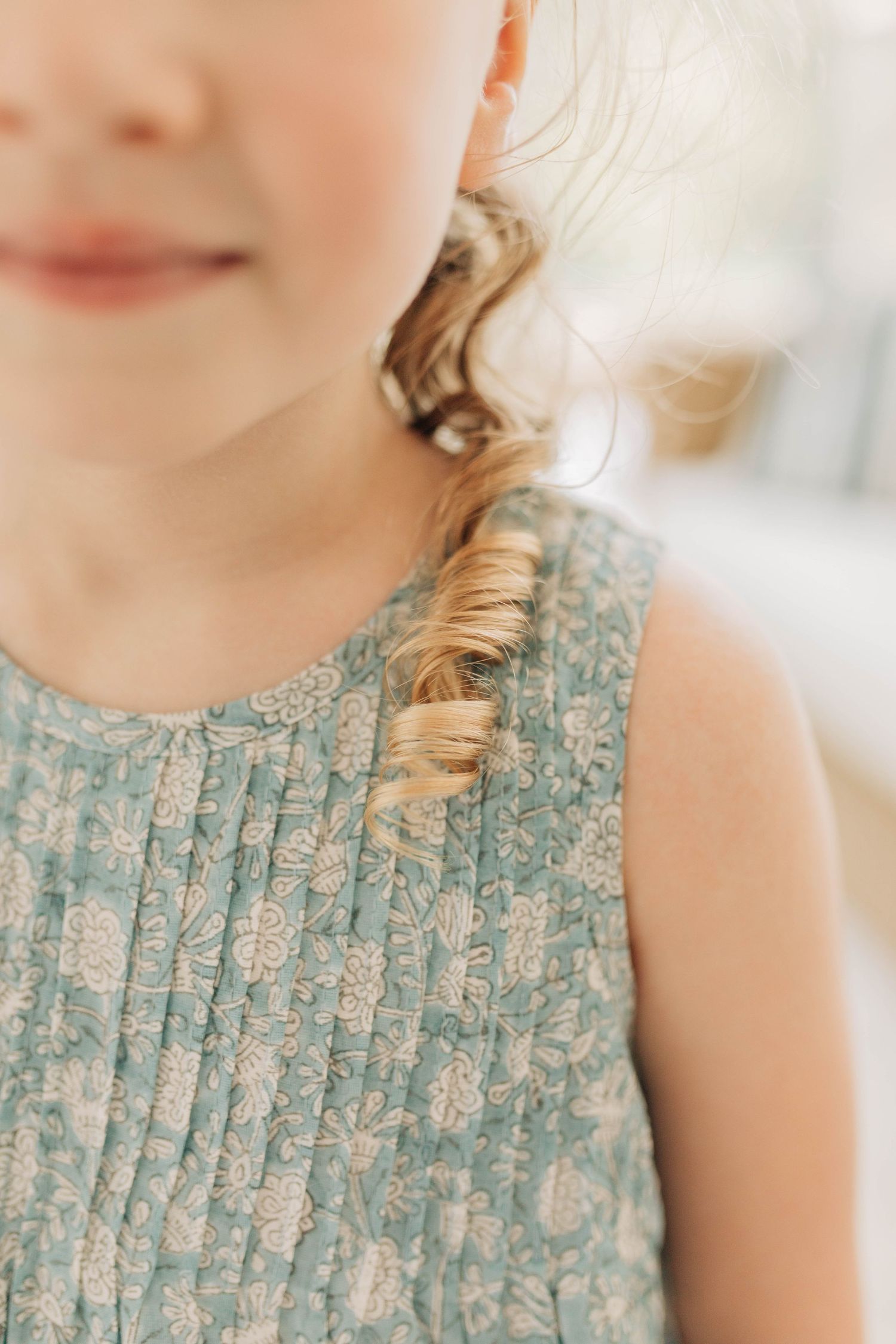 Close-up detail shots of a delicate blue and white floral patterned dress.