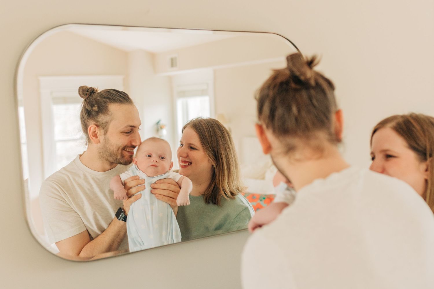 Happy family moments reflected in decorative wall mirror.