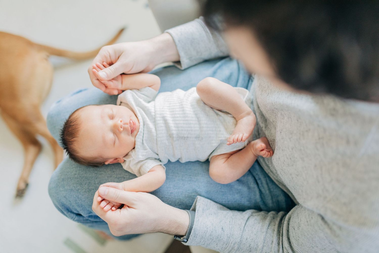 Close-up view of tiny baby feet being held with care.