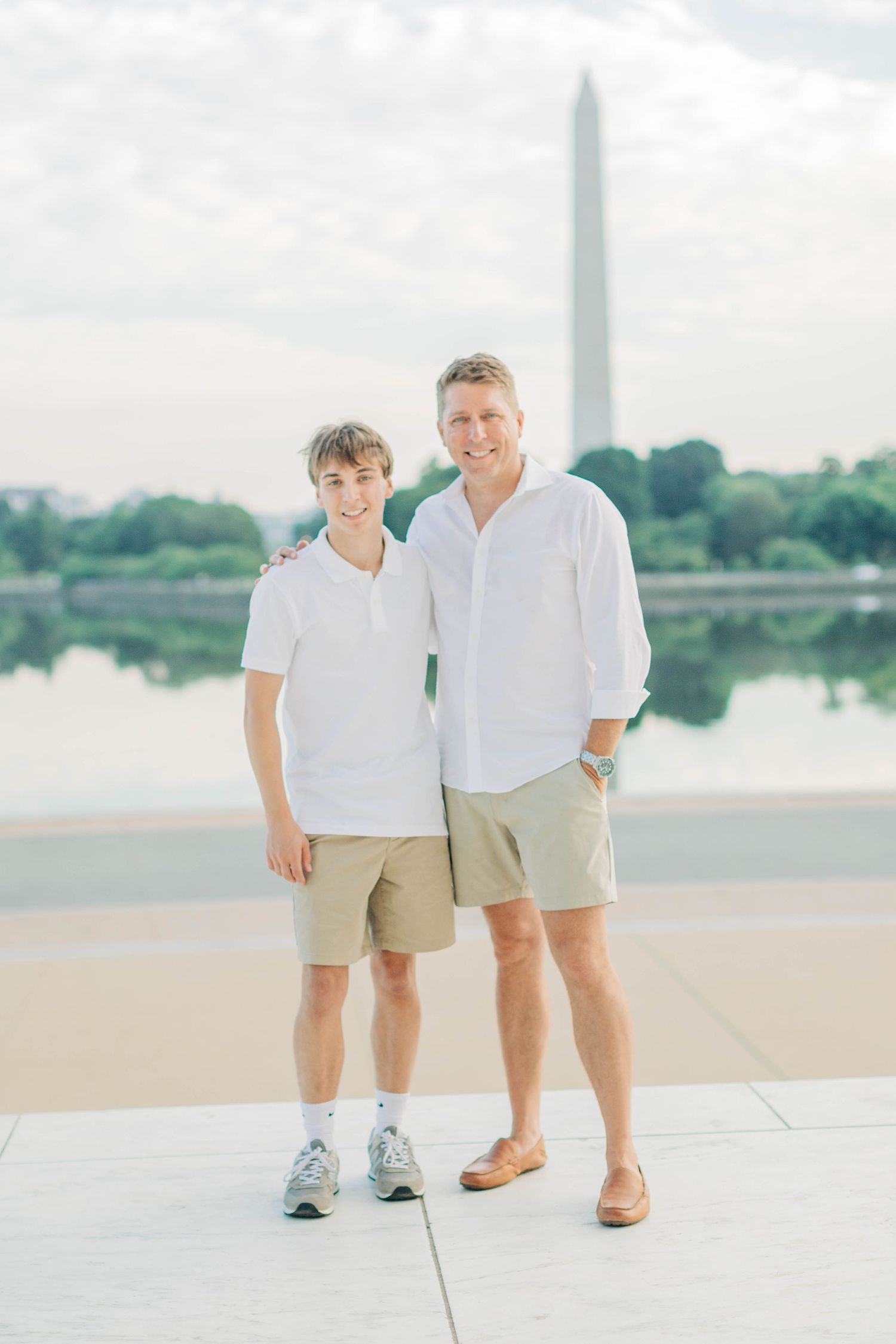 Father and son in matching khaki shorts pose at the Jefferson Memorial.