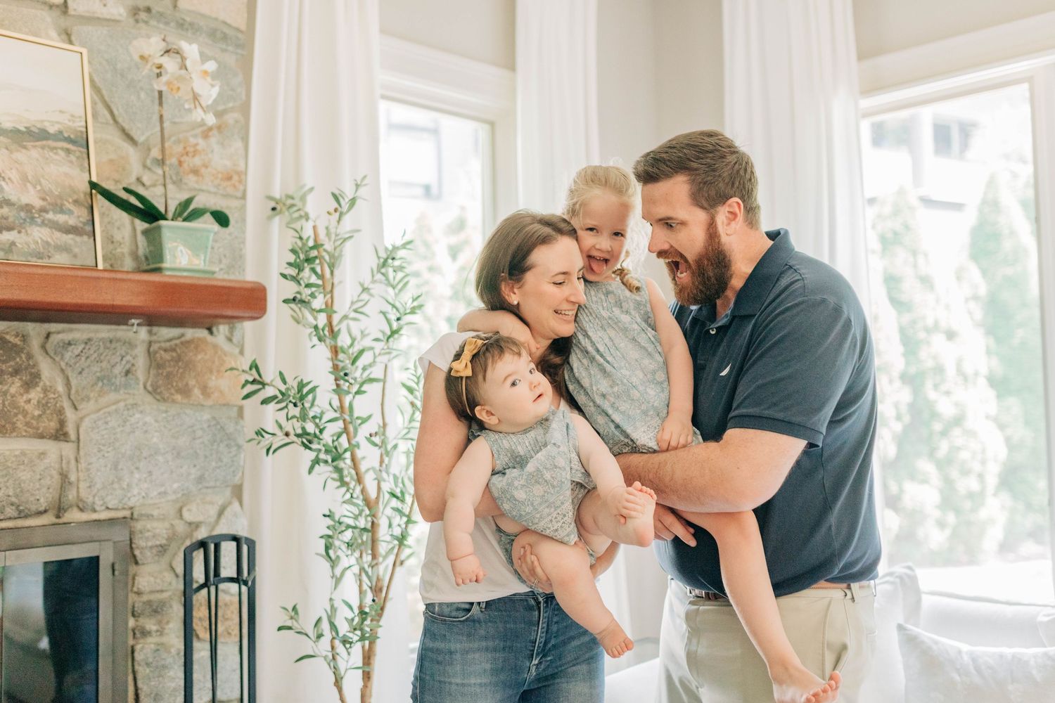 Sweet family moments shared in a bright, modern living room with natural decor.