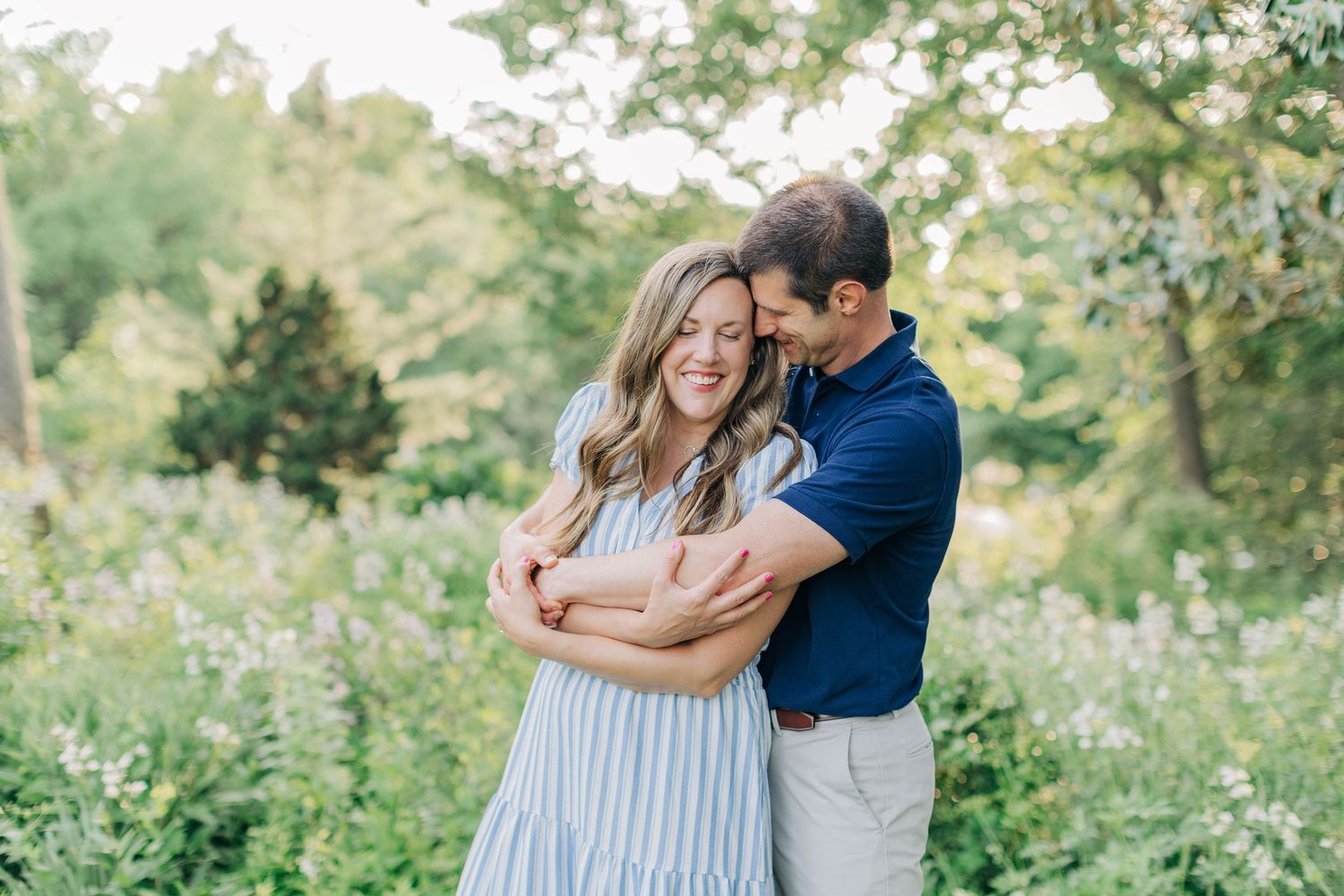 Candid moments of a couple laughing and hugging in a natural outdoor setting.