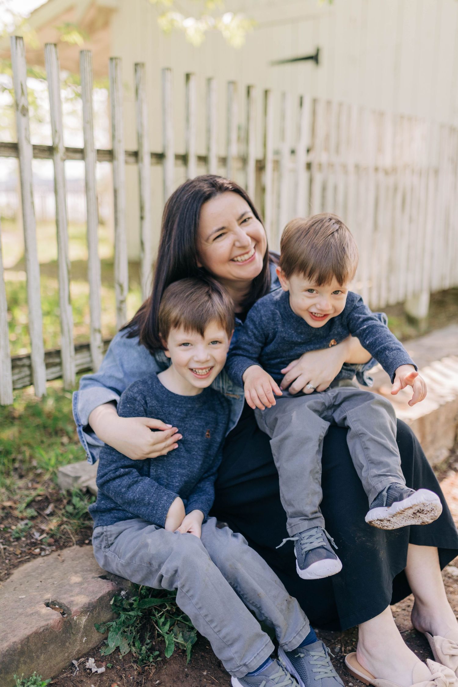 Candid family moments captured on white steps showing natural joy and connection.