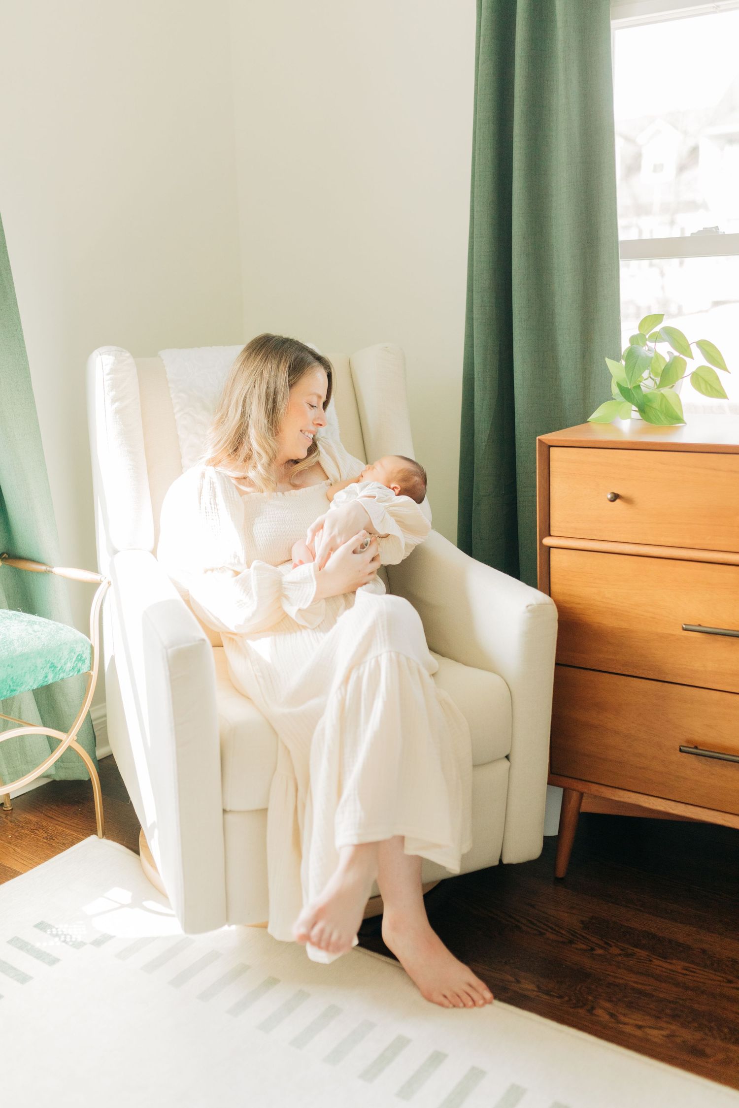 Sunlit room with wooden dresser and green curtains during lifestyle session.