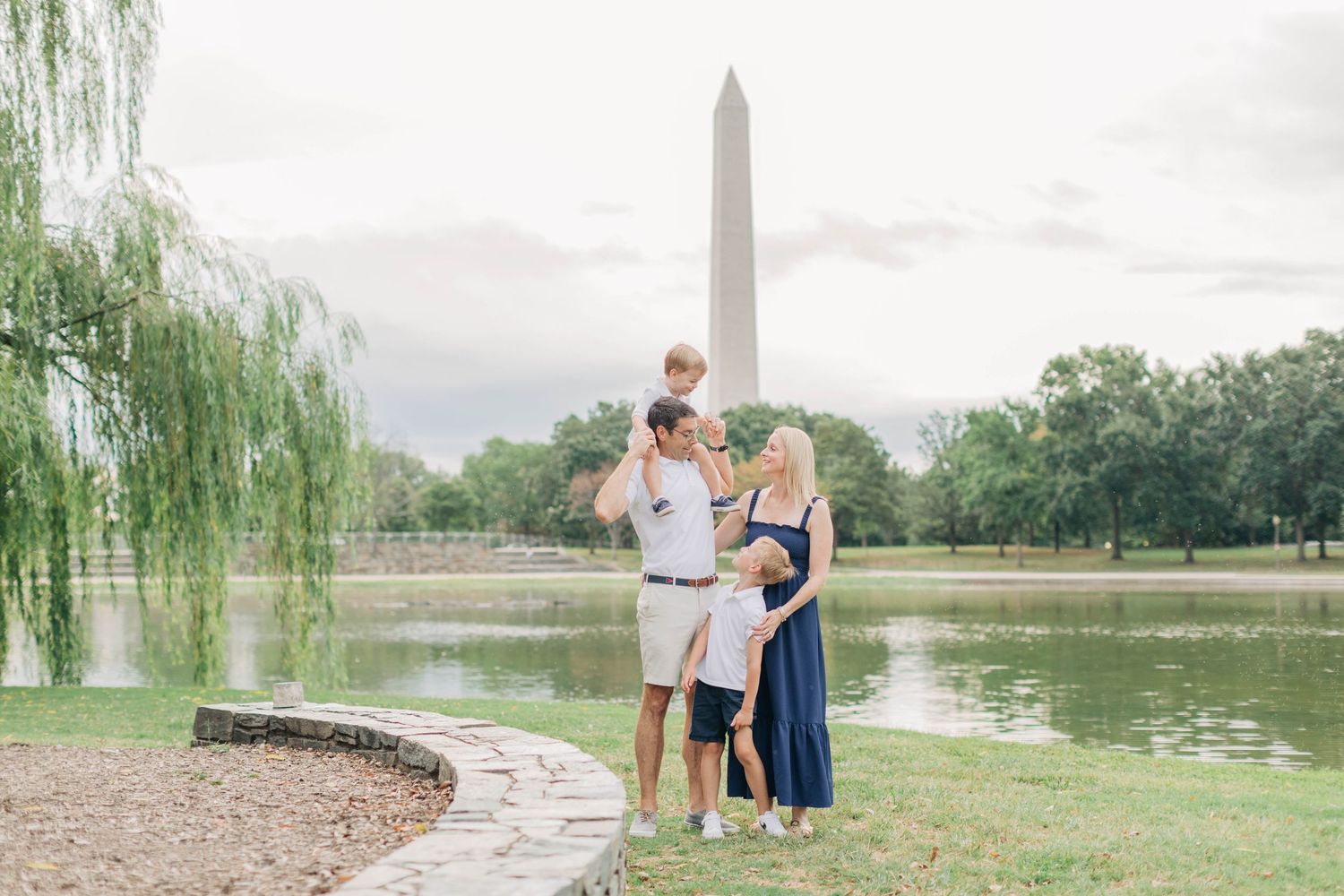 A scenic family photoshoot by the reflecting pool at the National Mall.