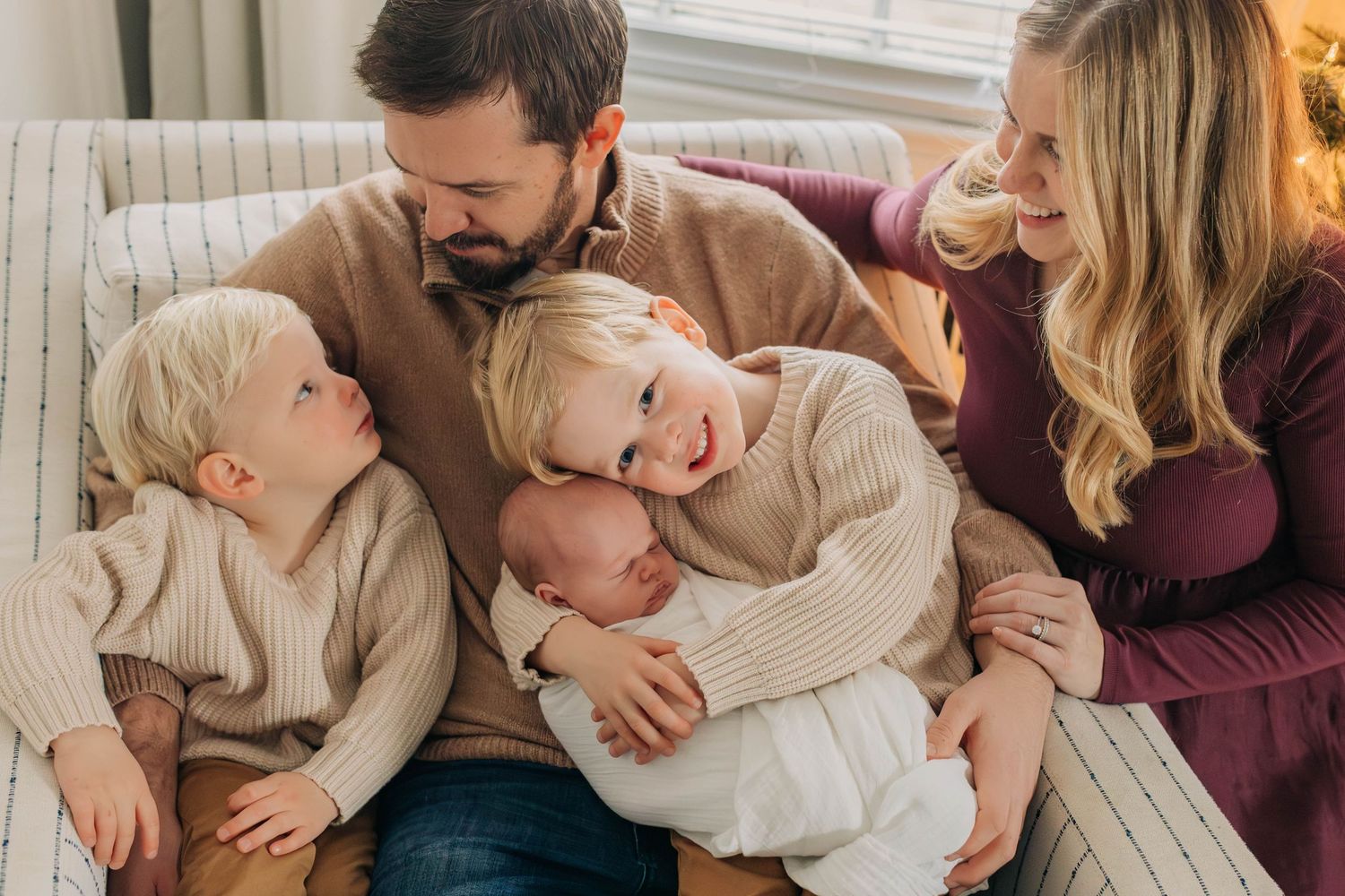 A cozy family moment together on a sofa in their living room.