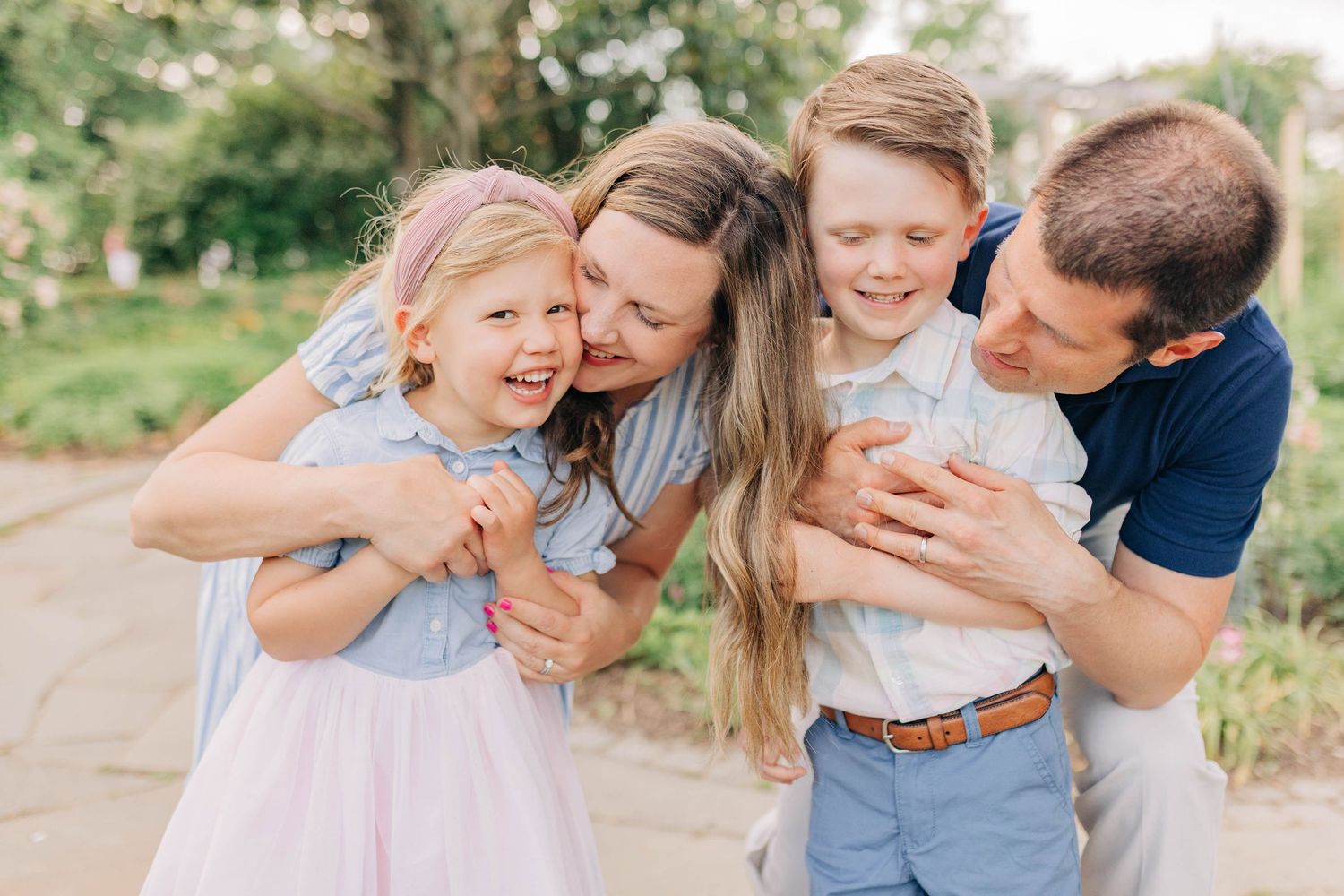 Natural family moments captured during an outdoor photo session in a garden.