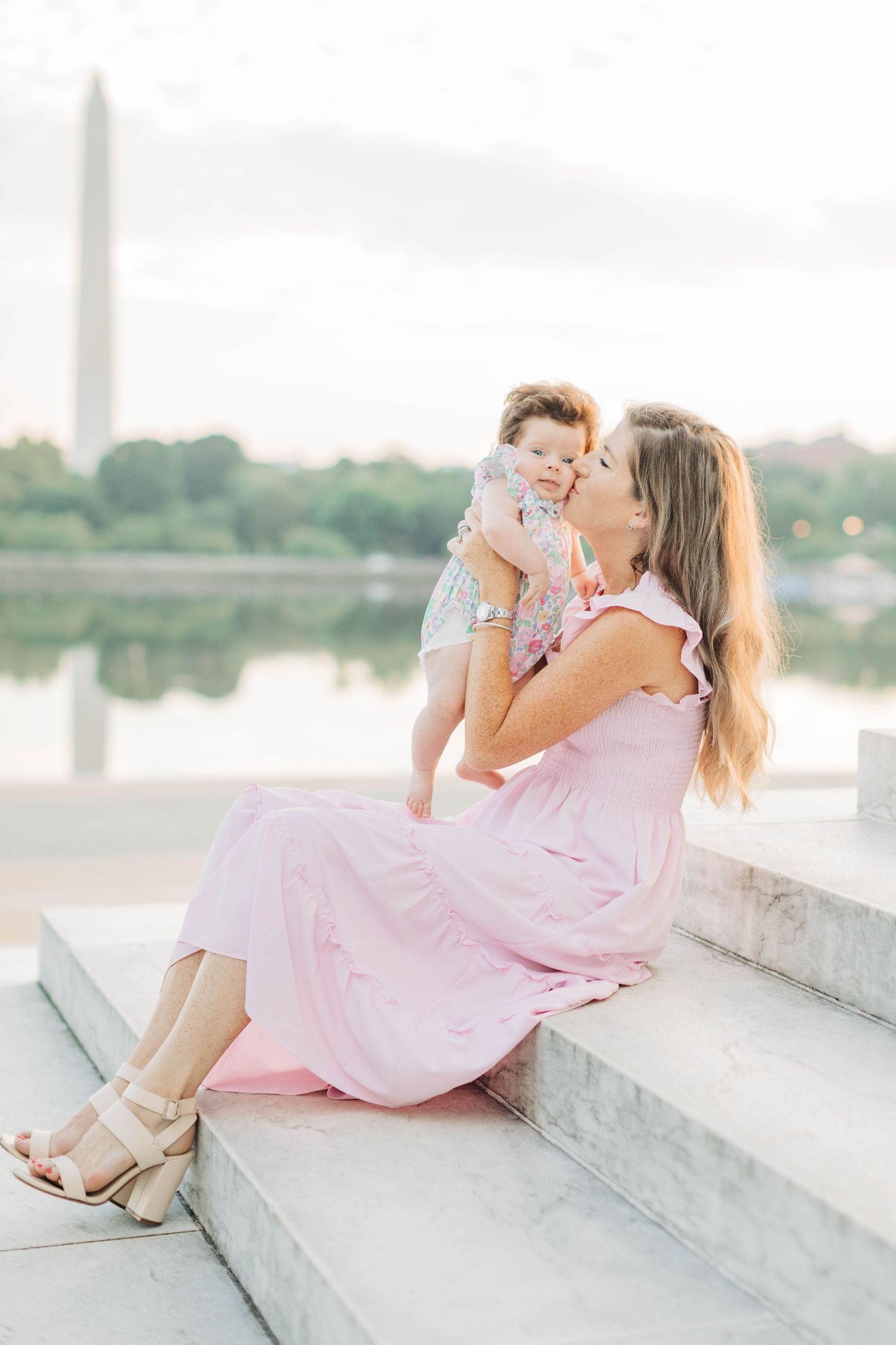 A tender moment captured at the Jefferson Memorial with the Washington Monument reflecting in the Tidal Basin.